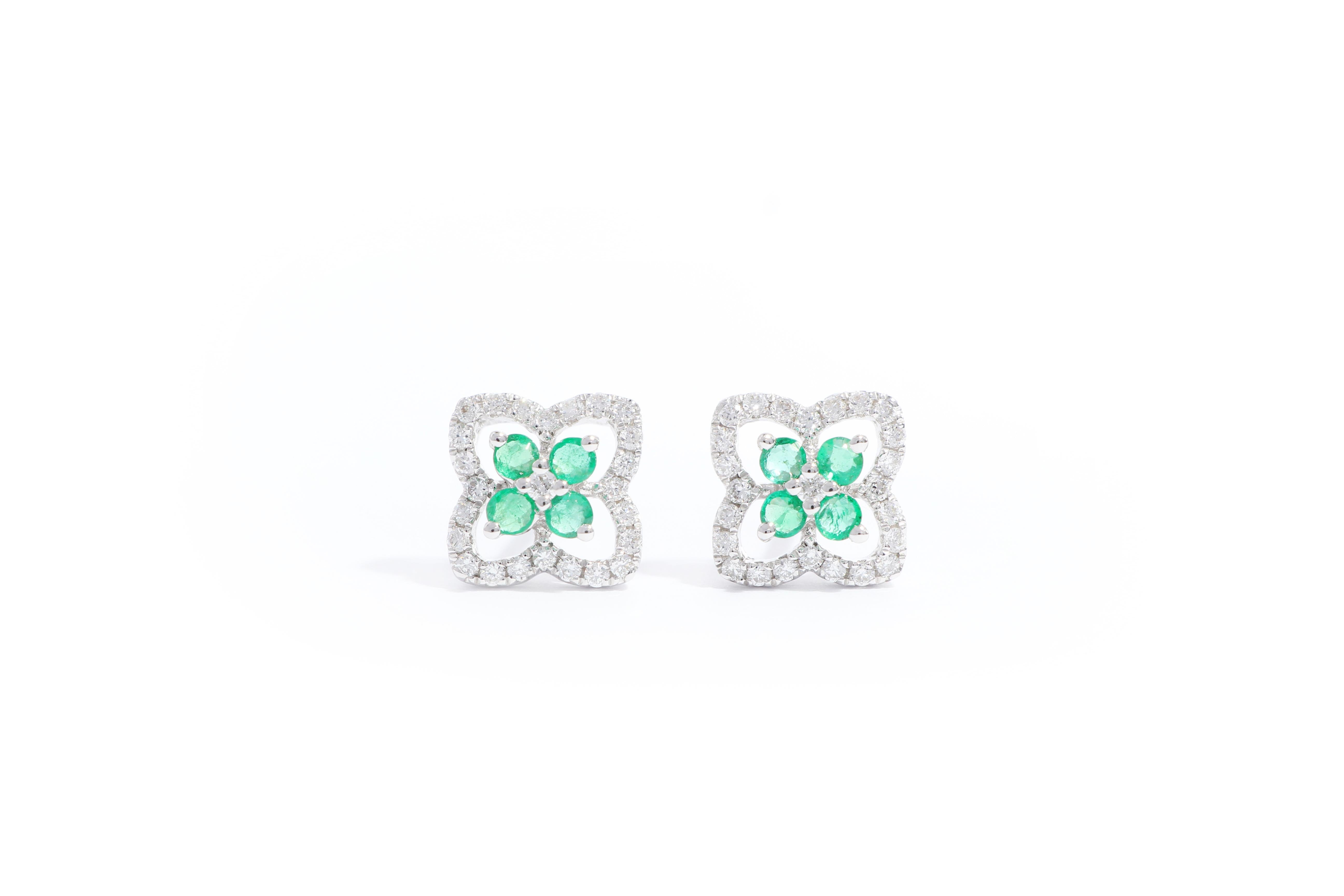 This Art Deco style earrings In the form of four leaf clover , simple and stylish, set with natural brilliant-cut emerald with beautiful green colour totaling 0.21cts, decorated with brilliant-cut diamonds weighing 0.20cts, mounted in 18 karat white