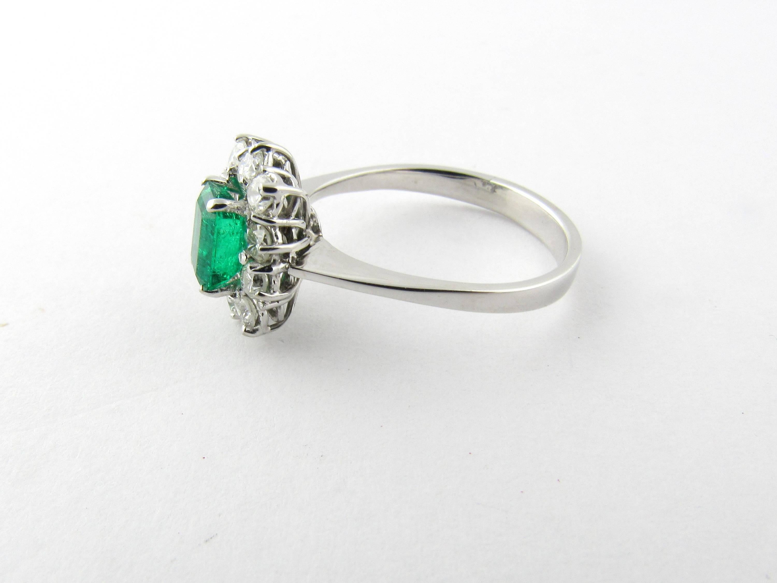 Vintage 18 Karat White Gold Emerald and Diamond Ring Size 7.5- 
This stunning ring features a lovely emerald cut emerald surrounded by 10 round brilliant cut diamonds set in 14K white gold. 
Approximate total diamond weight: .70 ct. 
Diamond