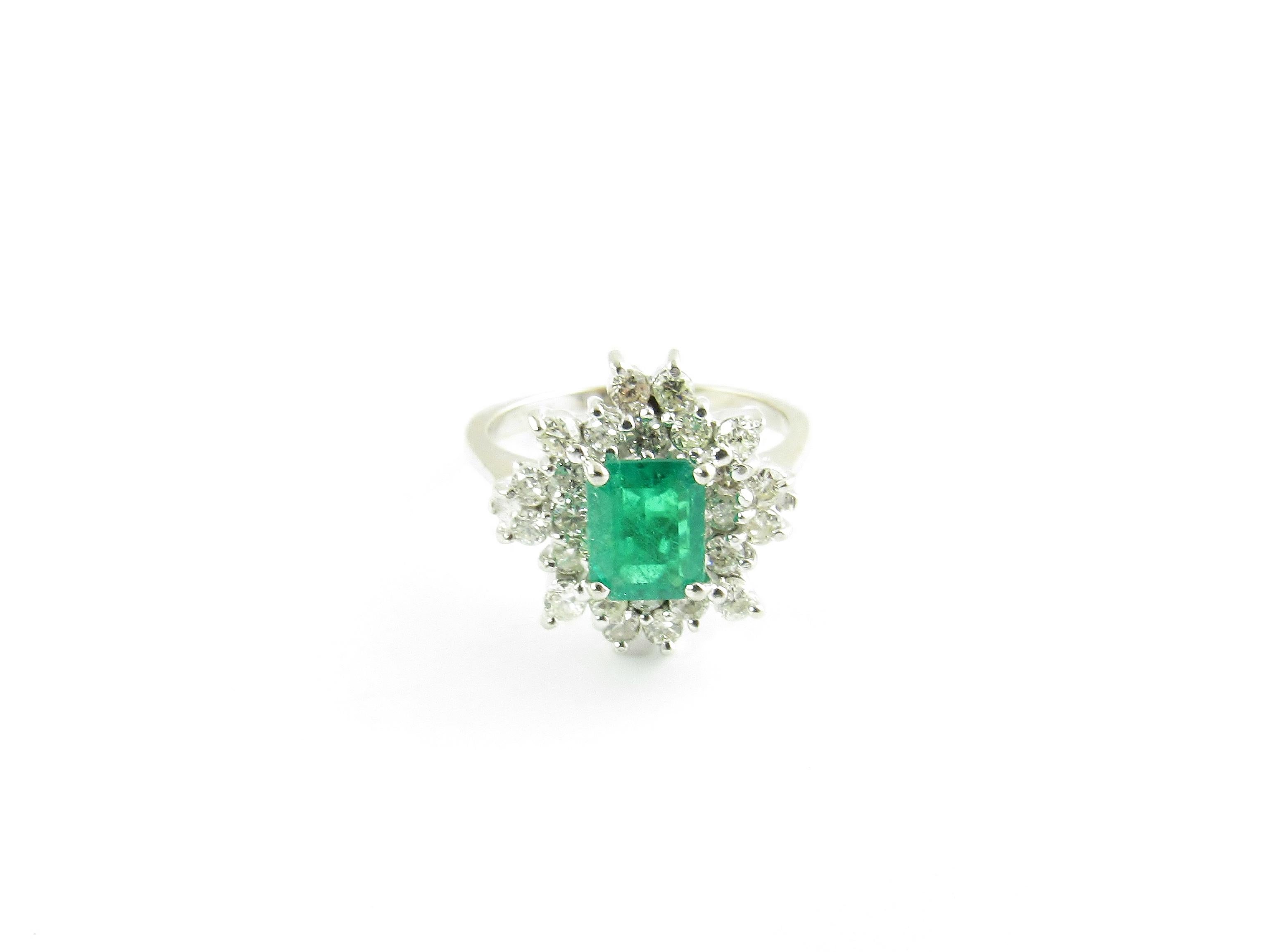 Vintage 18 Karat White Gold Emerald and Diamond Ring Size 7-

This stunning ring features one emerald cut emerald (7 mm x 5 mm) surrounded by 24 round brilliant cut diamonds set in classic 14K white gold. Top of ring measures 15 mm x 15 mm. Shank