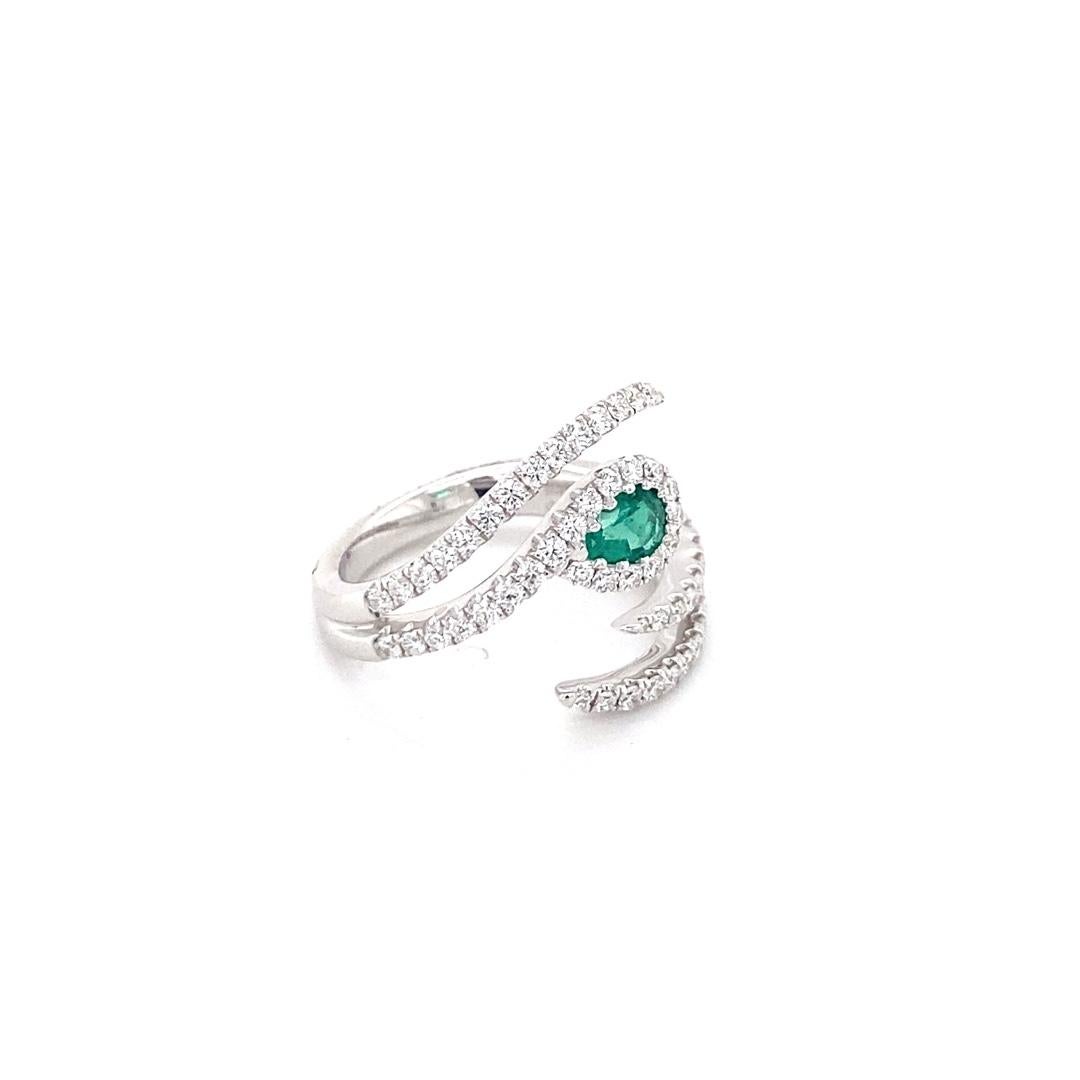 Here we have a stunning ring that is made of 18 karat white gold with a 0.29ct pear shaped emerald. This piece features a bypass design with 0.78cttw of diamonds. The ring is a size 6.5. This gorgeous ring makes the perfect statement piece for any