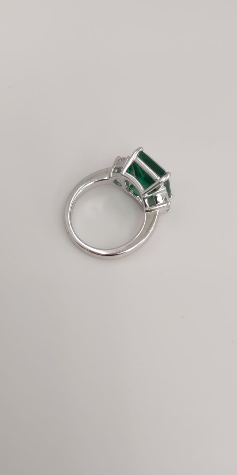 18 Karat White Gold Emerald Cut Emerald and Diamond Three-Stone Ring In New Condition For Sale In Great Neck, NY