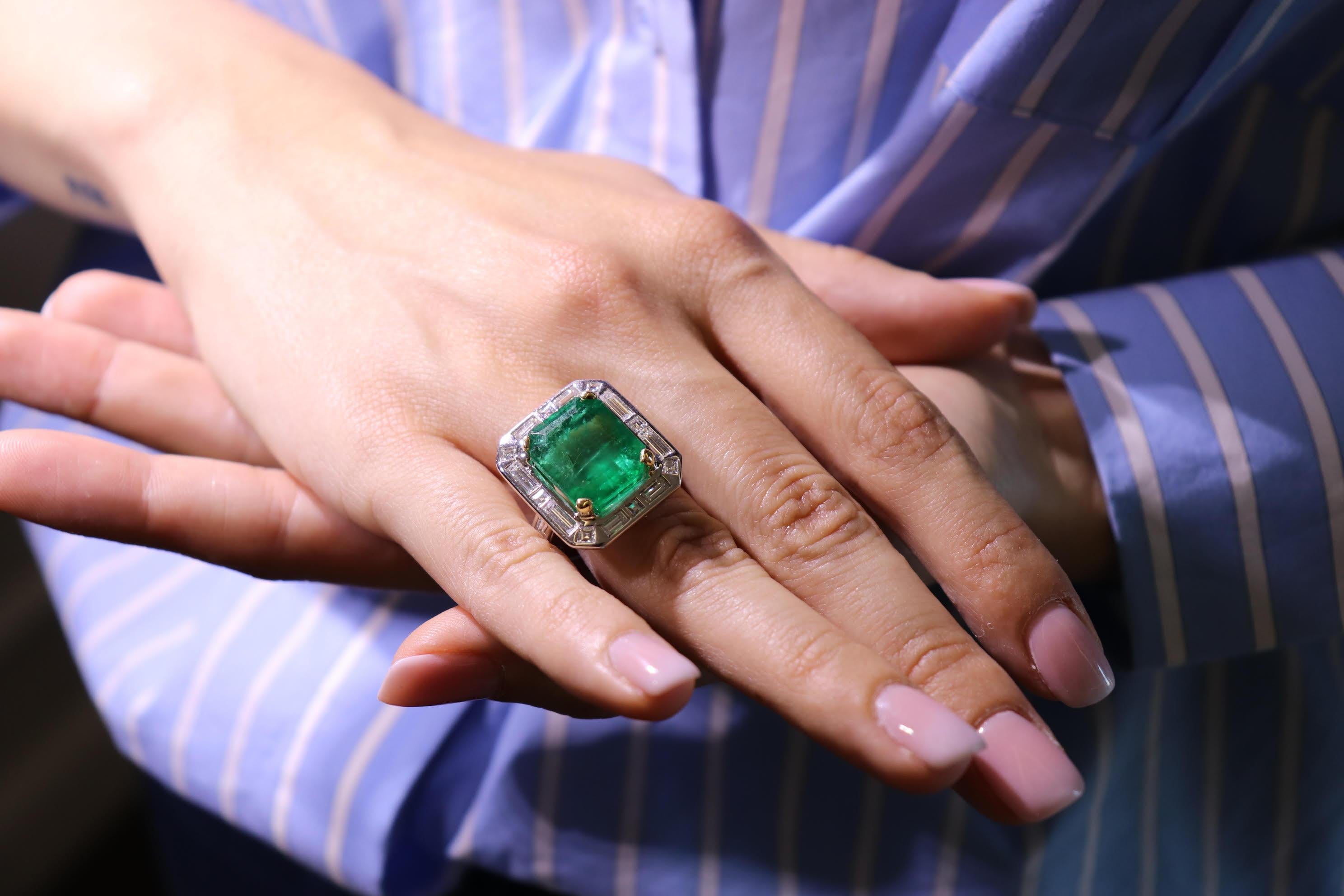This 18K white gold stunning ring is from our Timeless Collection. It is made of a beautiful emerald cut emerald 14.9 Carat decorated by natural colorless baguette, square and tapered shape diamonds in total of 1.96 Carat. Total metal weight is