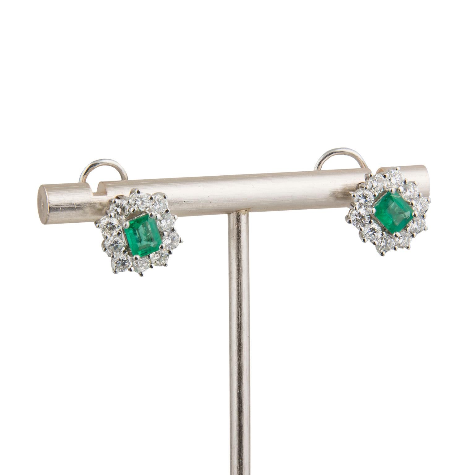 Earrings in 18 Karat white gold centered by two emeralds, surrounded by 24 round brilliant cut diamonds totalling 1.40 carats in weight.
Diameter: 1.3 cm (0.51 in)
