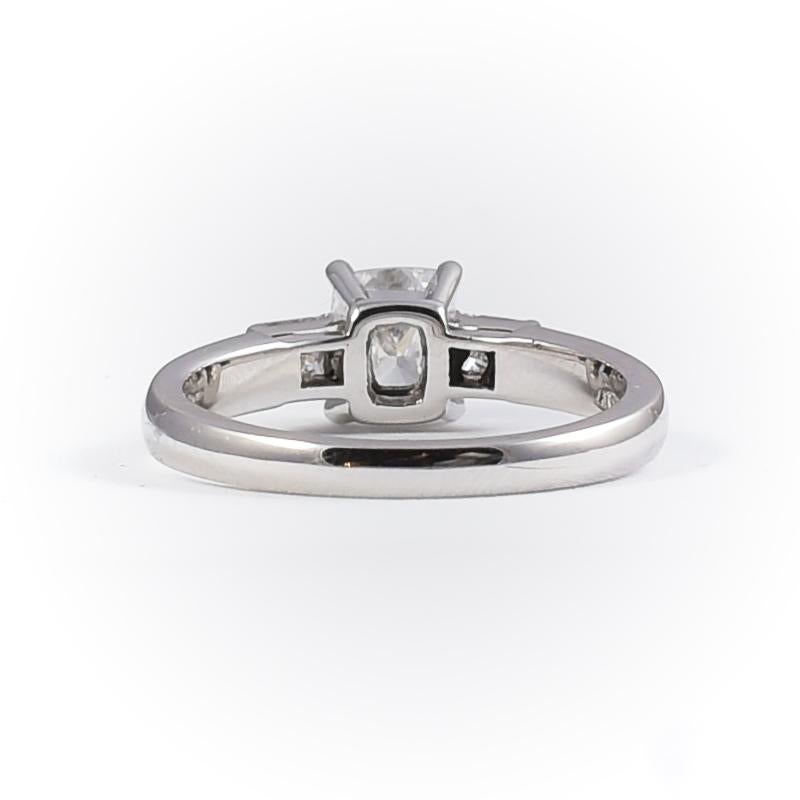 18 k white gold engagement solitaire ring with 1 diamond cushion cut 1.01 carats color E, clarity VS2 IGI cert. and 2 baguette cut diamonds 0.33 carats 