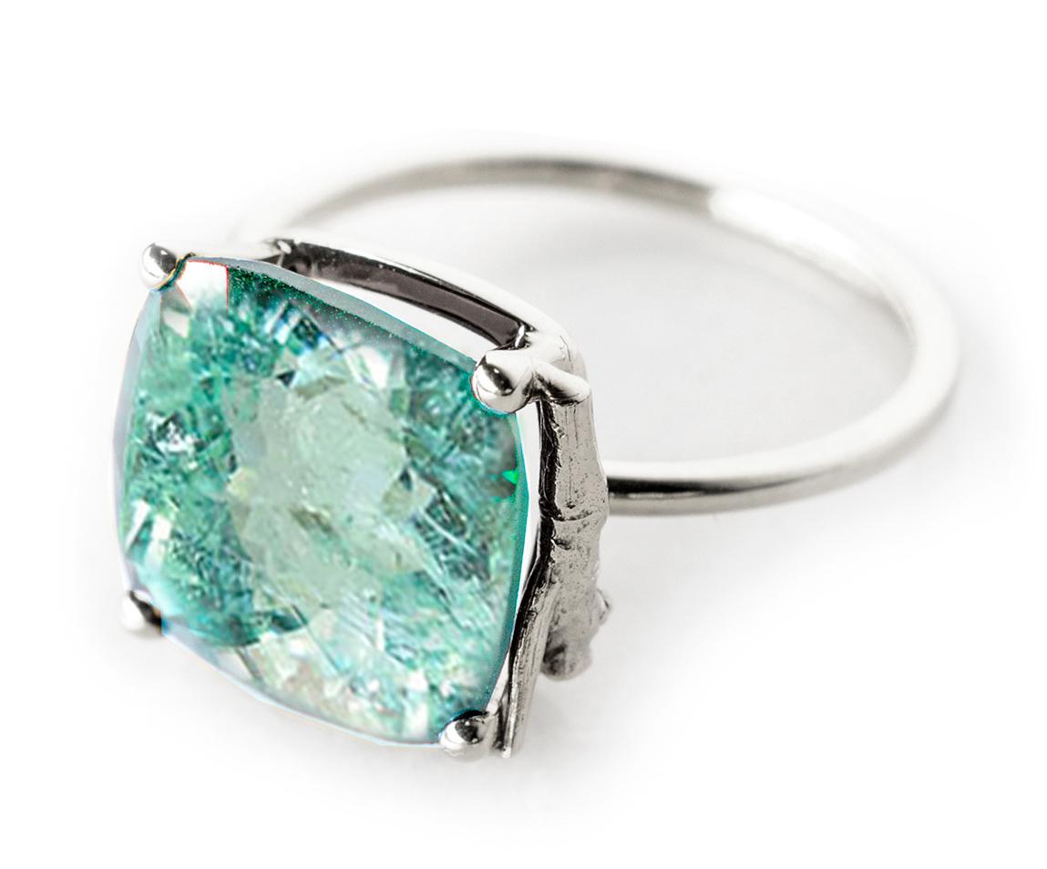 This ring is in 18 karat white gold with huge 4.35 carats neon copper bearing Paraiba tourmaline (11.6x9 mm). The gem is already pretty big, therefore it catches eye's attention by fine jewellery accurate work of tiny prongs, and exquisite neon
