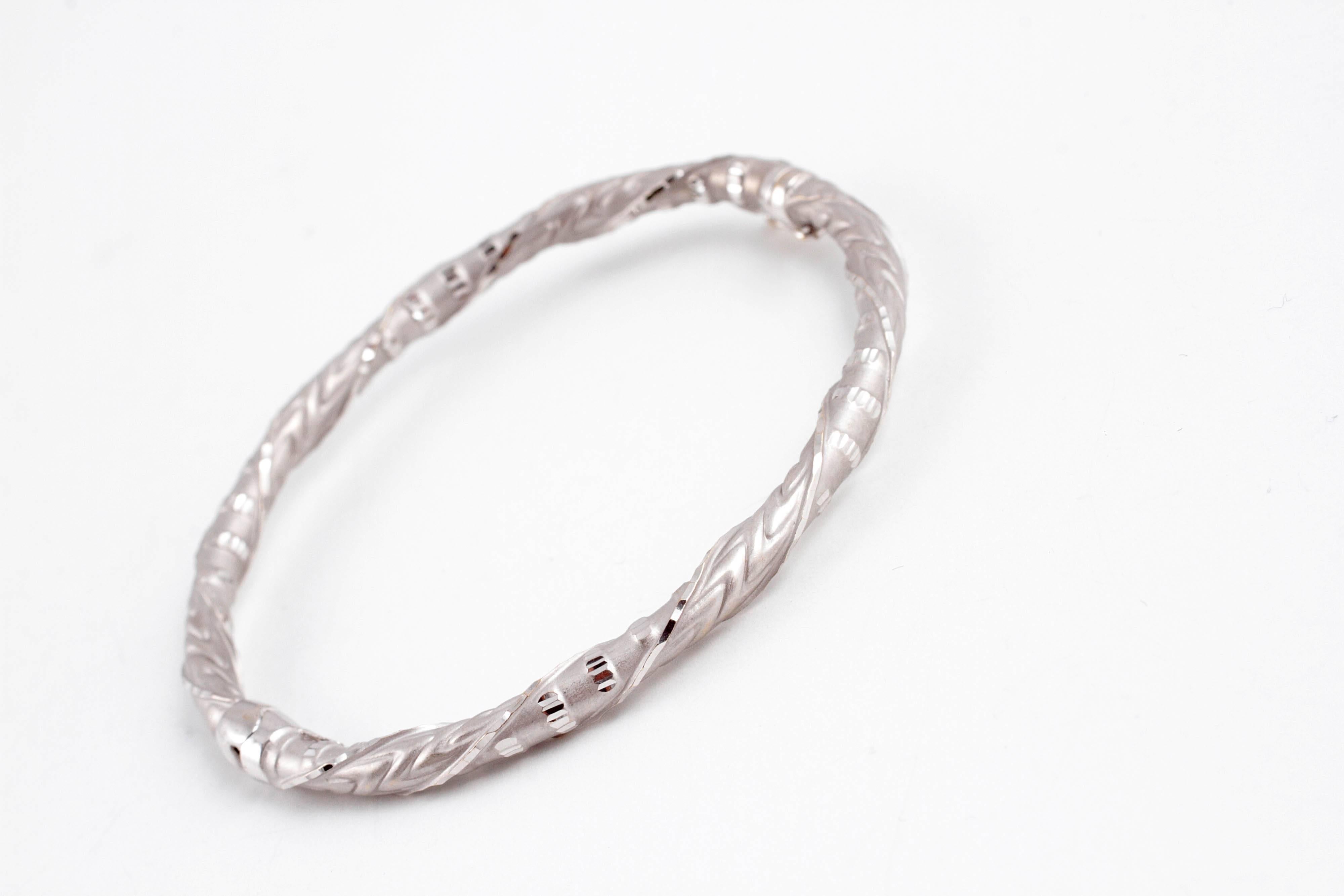 Highly-polished and matte finished, etched bangle, secured with a safety catch.  Layer it or wear it alone! 