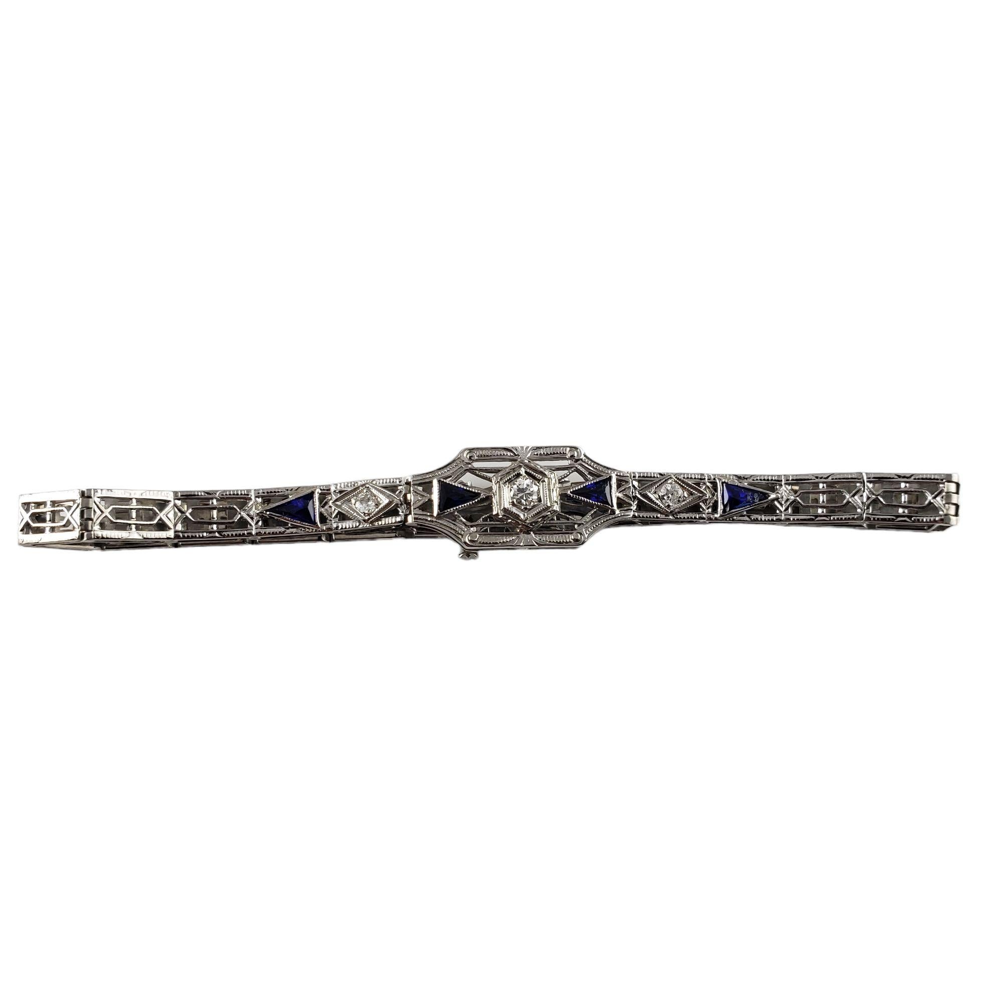 Vintage 18 Karat White Gold Filigree Diamond and Blue Glass Bracelet-

This stunning bracelet features four triangular blue glass pieces * and three round old mine cut diamonds ** set in beautifully detailed 18K white gold filigree.  Width:  10