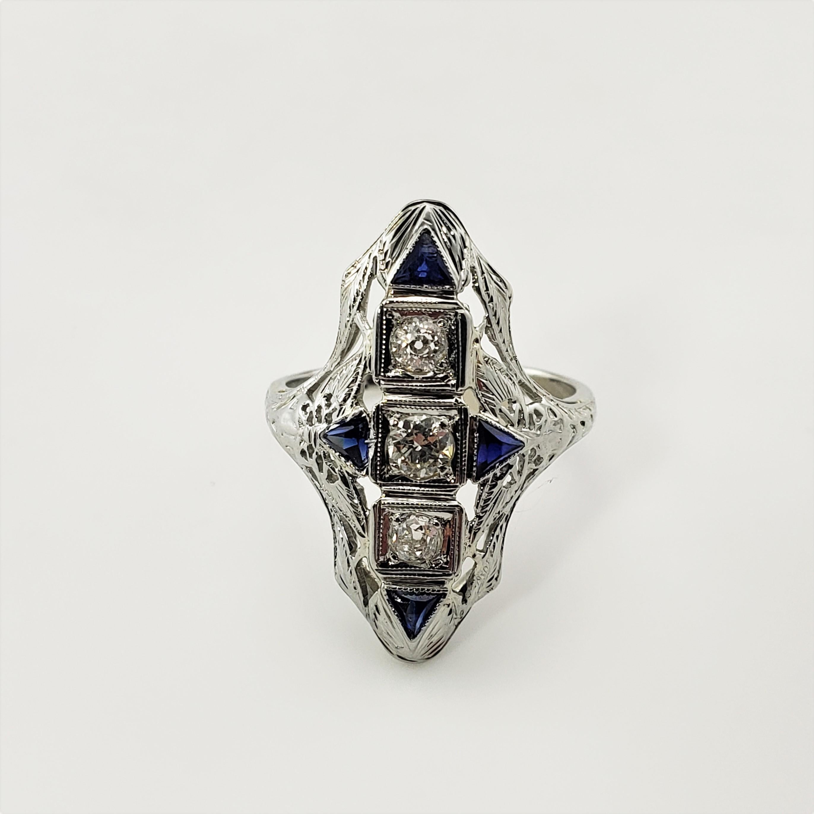 Vintage 14 Karat White Gold Filigree Diamond and Synthetic Sapphire Ring Size 6-

This lovely ring features 1 round brilliant cut diamond (center),  two European cut diamonds* , and two triangle cut synthetic sapphires set in beautifully detailed