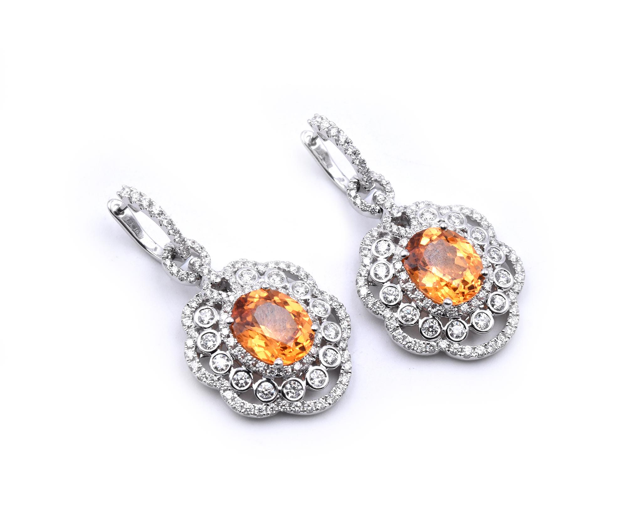 Designer: spark creations
Material: 18k white gold
Gemstone: 2 oval fire opals = 7.09cttw 
Diamonds: 206 round and baguette cut = 2.50cttw
Color: G
Clarity: VS
Dimensions: earrings measure 35.6mm x 18.5mm
Fastenings: snap closures
Weight: 14.52