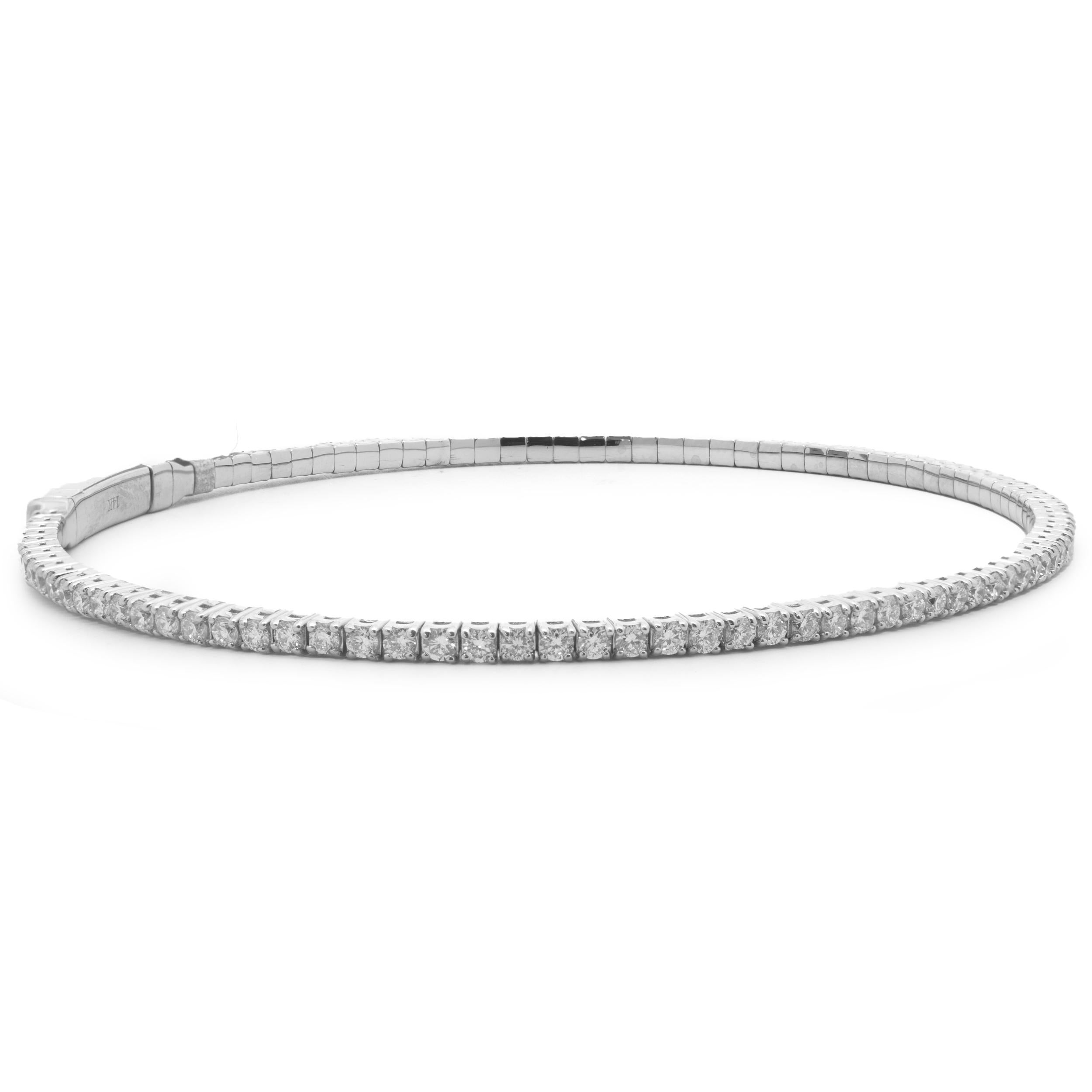 Designer: custom
Material: 18K white gold
Diamonds: round brilliant cut = 1.75cttw
Color: F/G
Clarity: SI1
Dimensions: bracelet will fit up to an 7-inch wrist
Weight: 6.84 grams

