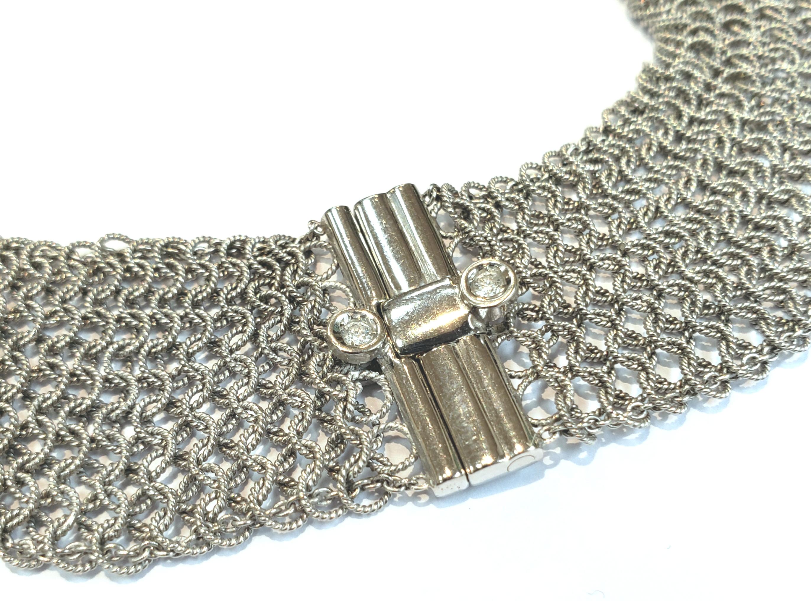18 karat white gold, one inch wide, flexible, textured mesh choker with 22 bezel set diamonds. The textured finish gives the piece a soft understated appearance.  Necklace has a push bar closure. It is curved to contour to the neck. It is made in