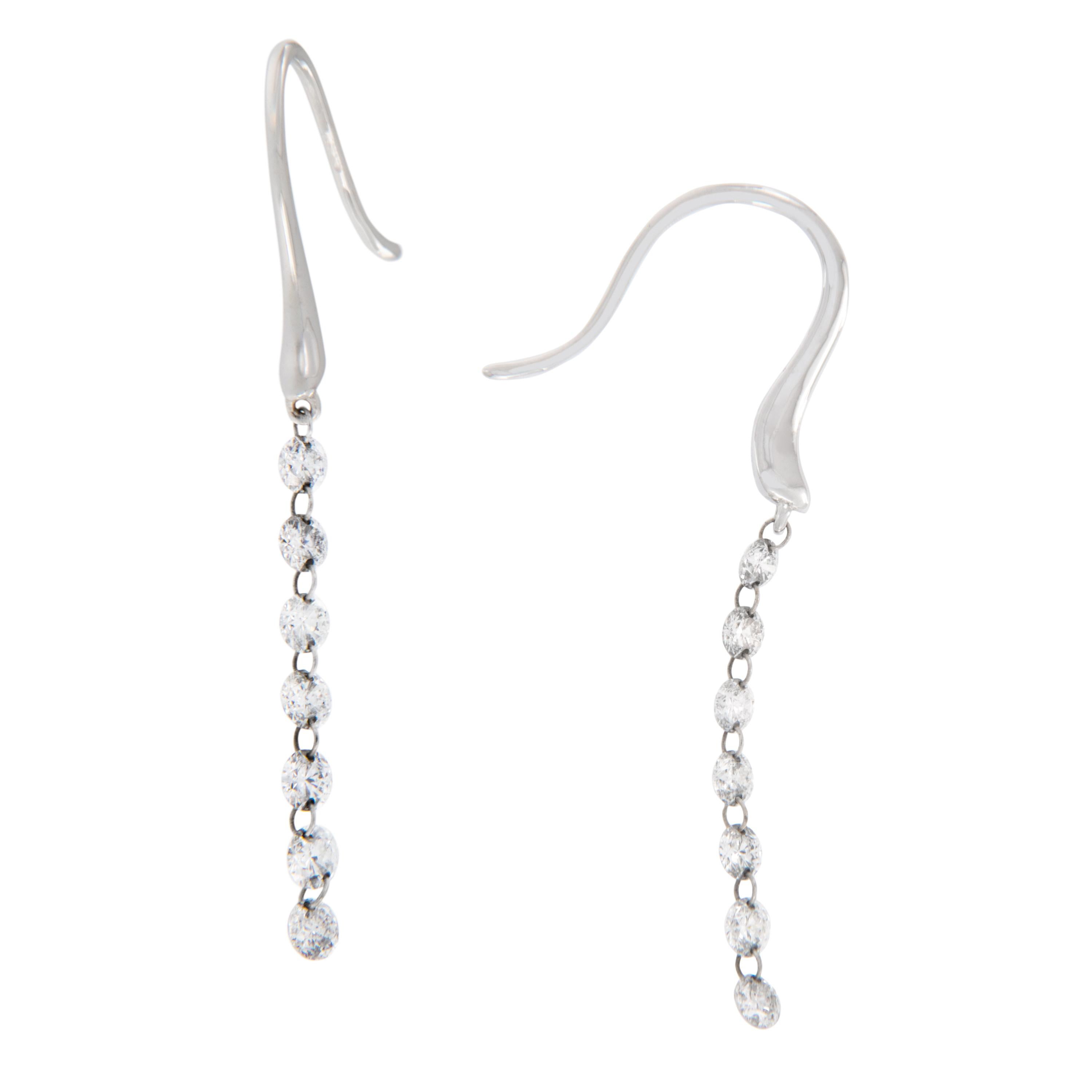 So fun and contemporary! These 18 karat white gold dangle diamond earrings contain 14 