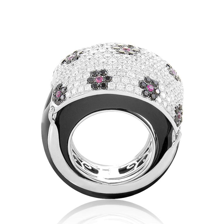 This exceptionally feminine ring glitters with a rare and luxurious elegance. The ring is made of 18 white gold and boasts shanks accented with black onyx. Lastly, the domed portion of the ring is set with a micro-pave comprised of white and black