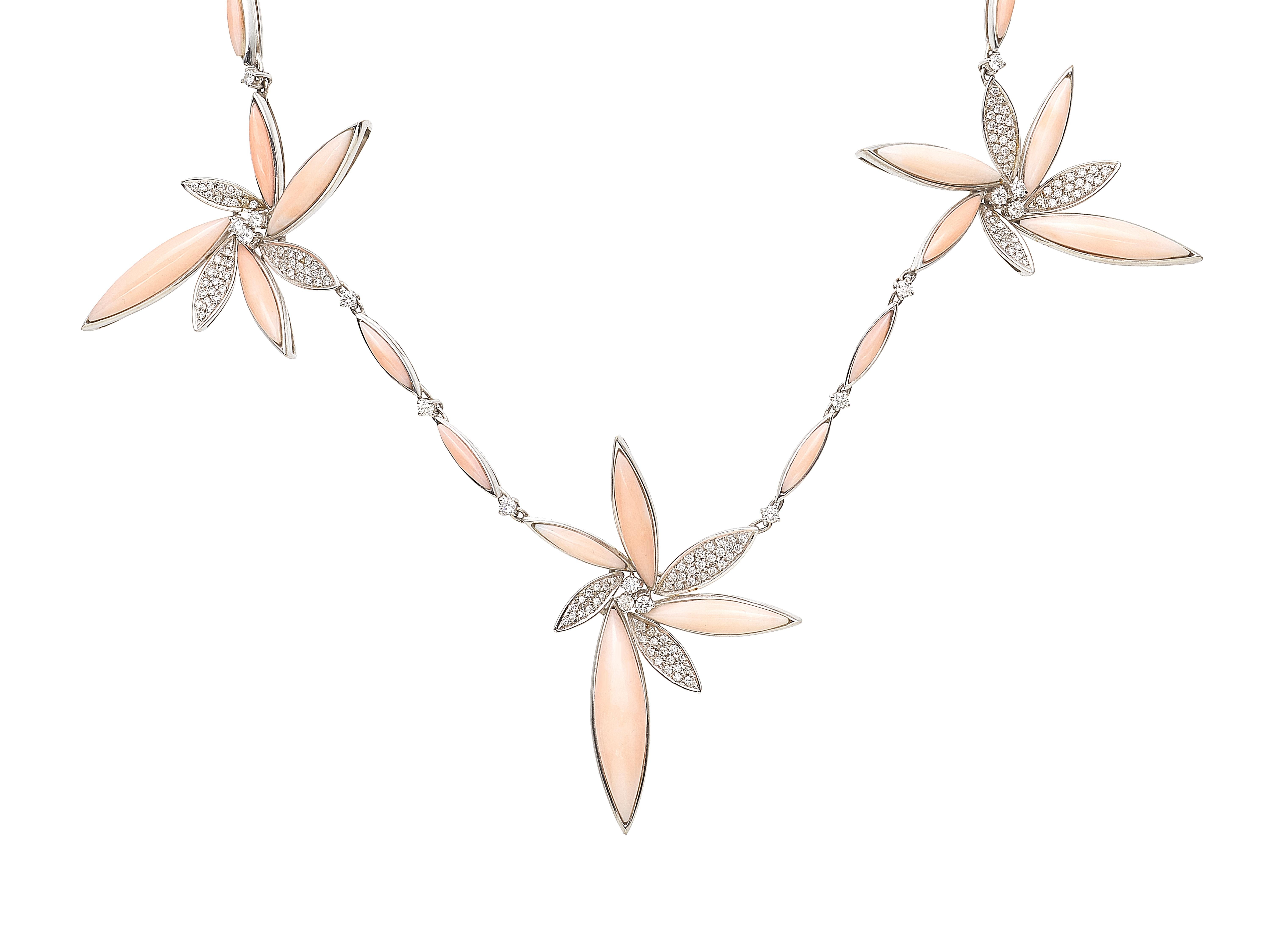 Beautiful floral collier in 18KT white gold with pink coral and diamonds. 
The necklace is made of three flowers in  spikes of coral and diamonds.  Diamonds have different sizes:  a diamonds pavè for 1.20ct and  21 diamonds for 1.05 ct. 
The whole