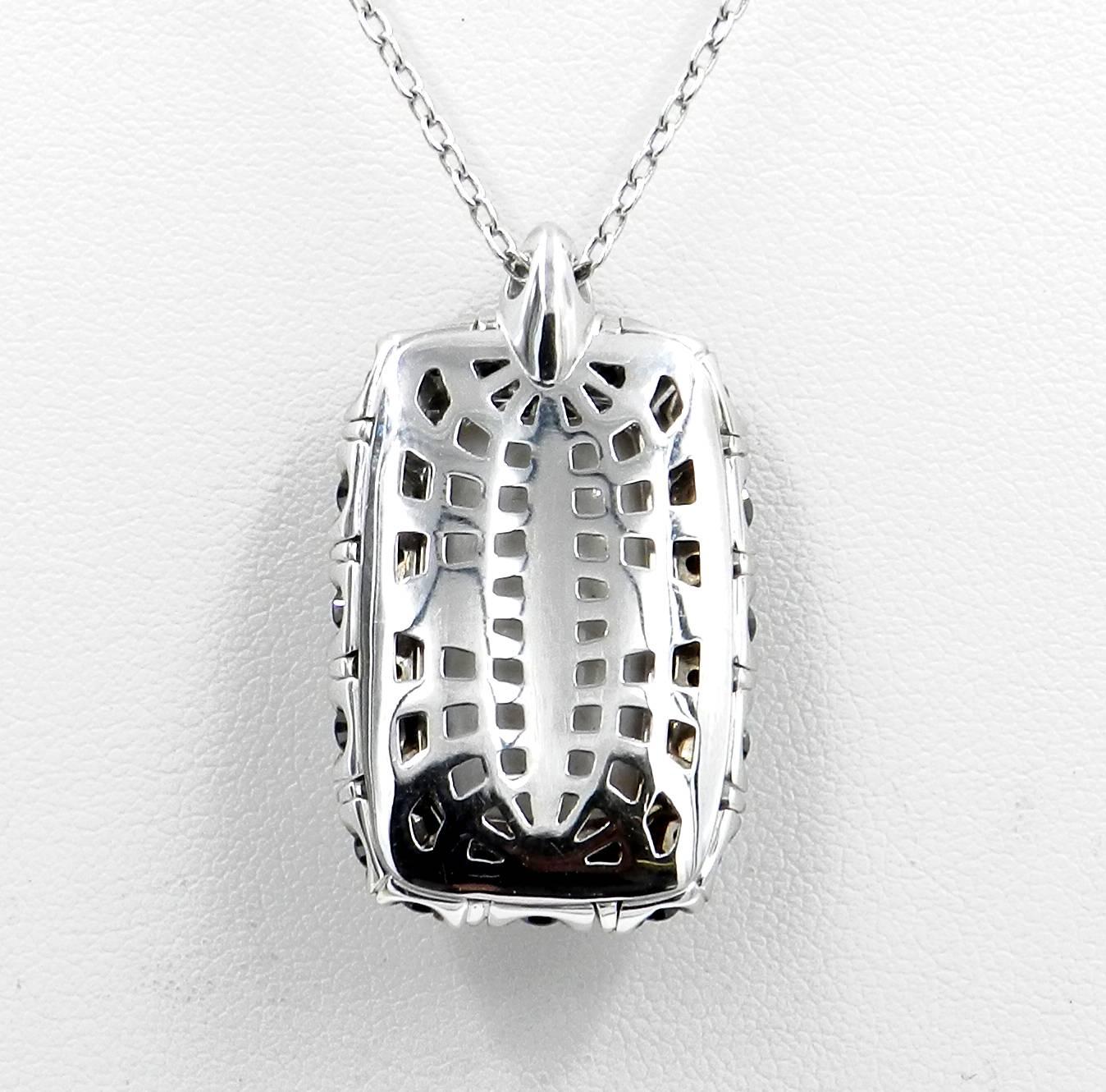  18KT White Gold GARAVELLI Pendant With Chain With BLACK DIAMONDS & WHITE COGOLON
The pendant measures MM.23X33
Chain lenght cm 48 with adjustement loop at cm 39
GOLD  :grs 15,70
BLACK DIAMONDS ct : 3,65
SEMIPRECIOUS WHITE COGOLON  ct : 17,75
Made