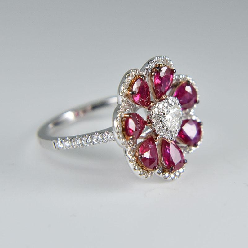 This gorgeous 18K White Gold flower ring featuring a 0.16 carat Heart shaped diamond and 7 glamorous Pear shaped rubies weighing 2.40 carat is surely your choice for Christmas! 

* Small diamonds weigh 0.46 carat.
Ring size US 6.

