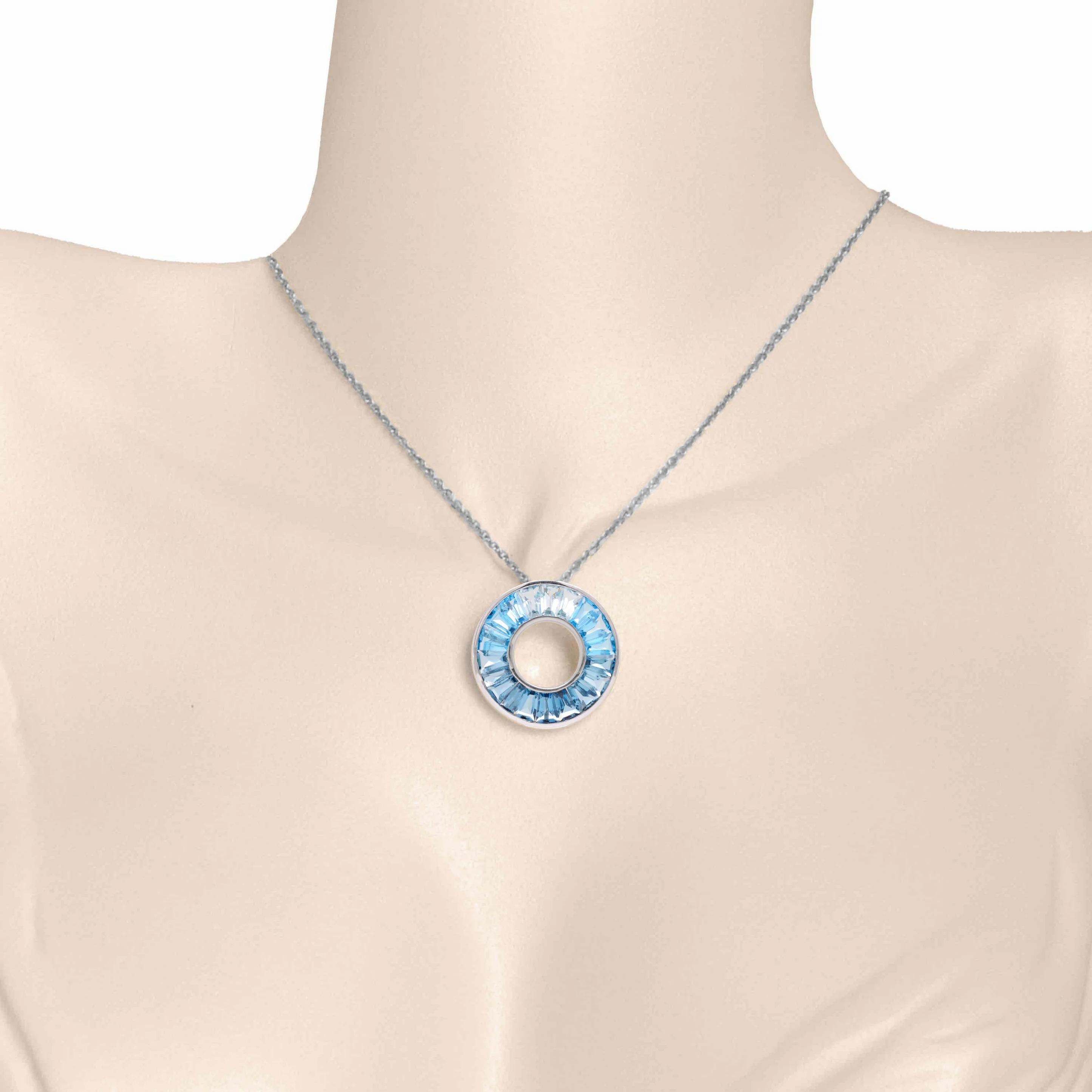 This exquisite 18K Gold Blue Topaz Circle Pendant Necklace, a true masterpiece that exudes elegance and sophistication. This necklace features a mesmerizing blue topaz gemstone in a circular setting, creating a perfect blend of timeless beauty and