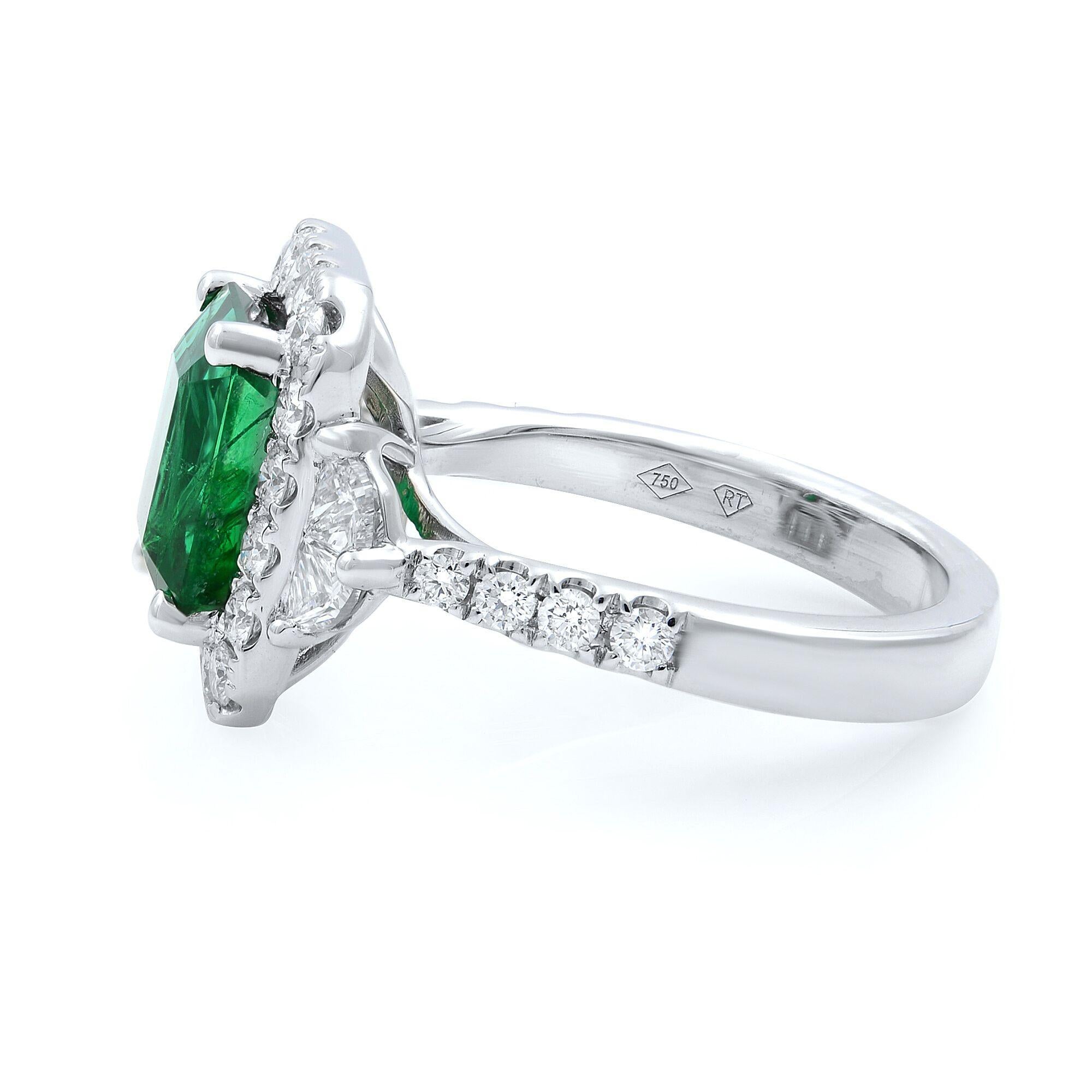 This stunning ring is set with emerald and shiny natural diamonds micro pave set halo and shank. Carat weight: emerald: 3.10cts, diamonds: 1.19cts. Crafted in 18K white gold. Ring size: 6.75. GIA certificate is included. 