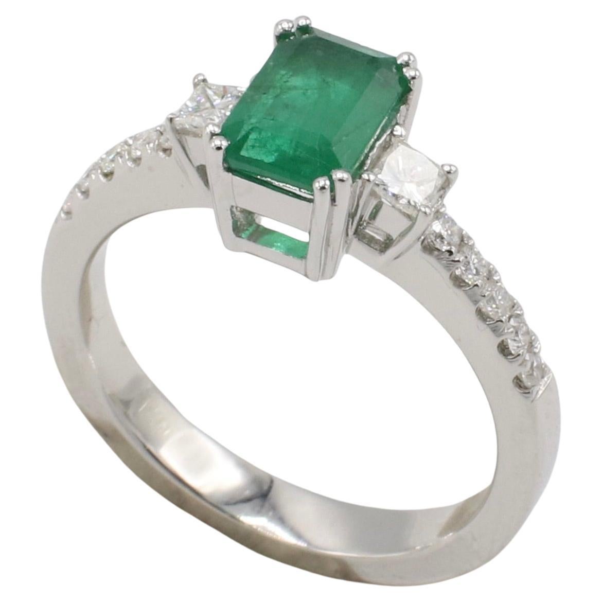 Esmeralda verde de oro blanco de 18 quilates y diamante natural Anillo de compromiso de cóctel 
Metal: oro blanco de 18 quilates
Peso: 4.72 gramos
Talla: 6.5 (US)
Banda: 2,8 mm 
Esmeralda 7 x 5 x 2,7 mm, aprox. 0,75 quilates
Diamantes: Aprox. 0,35