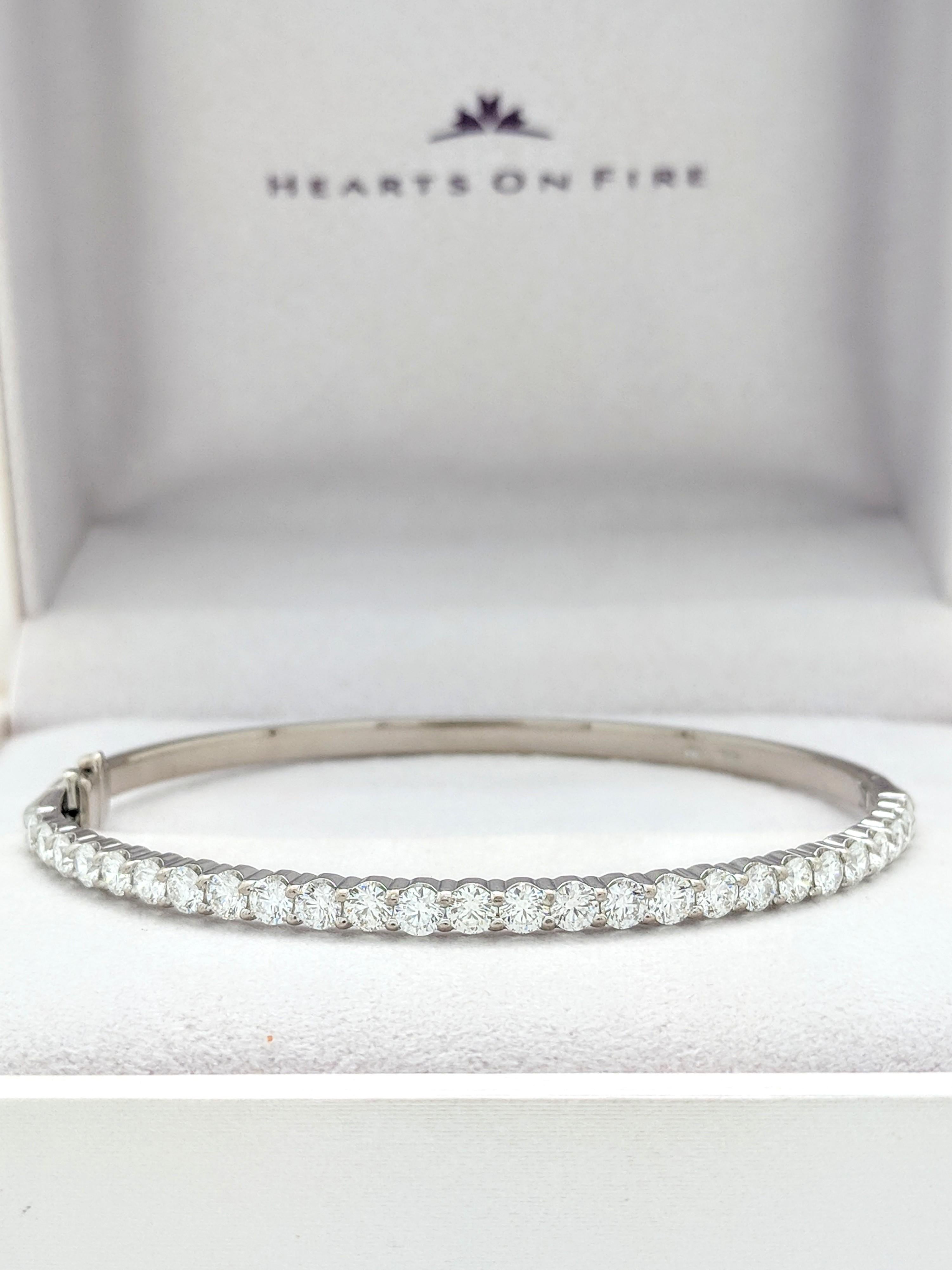 You are viewing a Stunning Hearts On Fire Diamond Bangle Bracelet.

Ladies classic 18k white gold hinged bangle with hidden clasp and hidden safety clasp, with high polish finish of cast construction. Bangle contains twenty-six shared prong Hearts