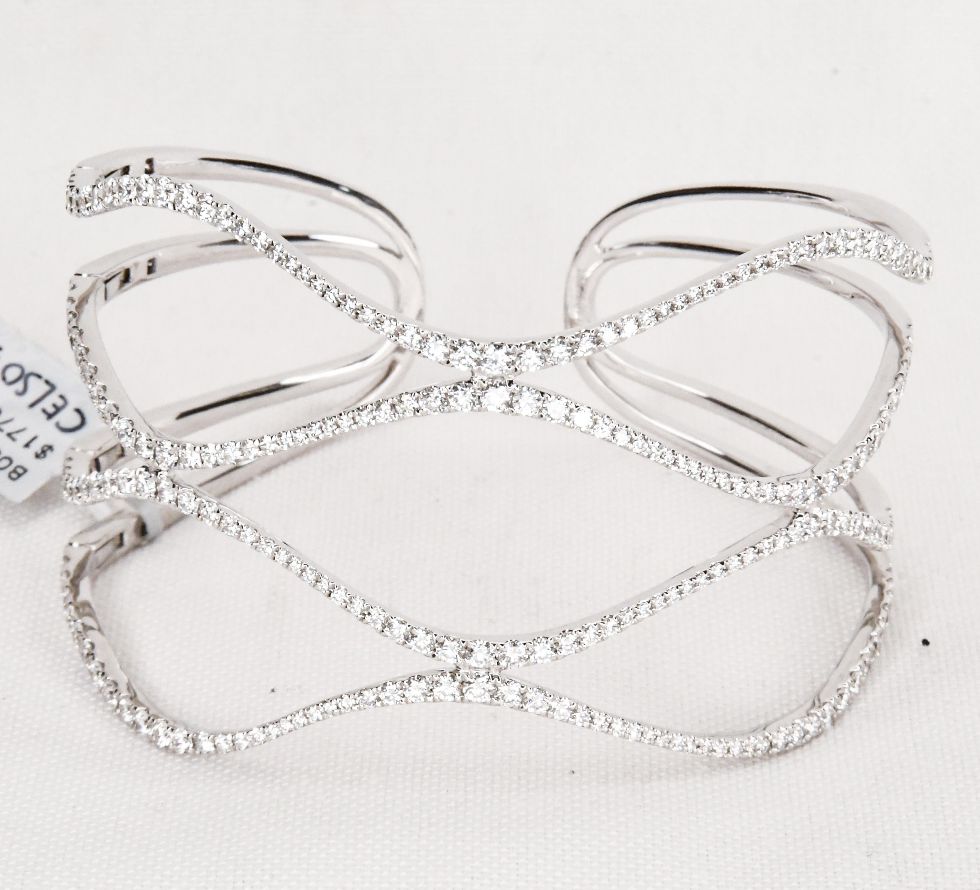 Artfully crafted in 18 karat white gold, this contemporary diamond pave hinged on one side open end cuff bracelet is stunning! Hinge on one side makes taking off and putting on a breeze!  Using 224 fully faceted perfectly matched diamonds having G-H