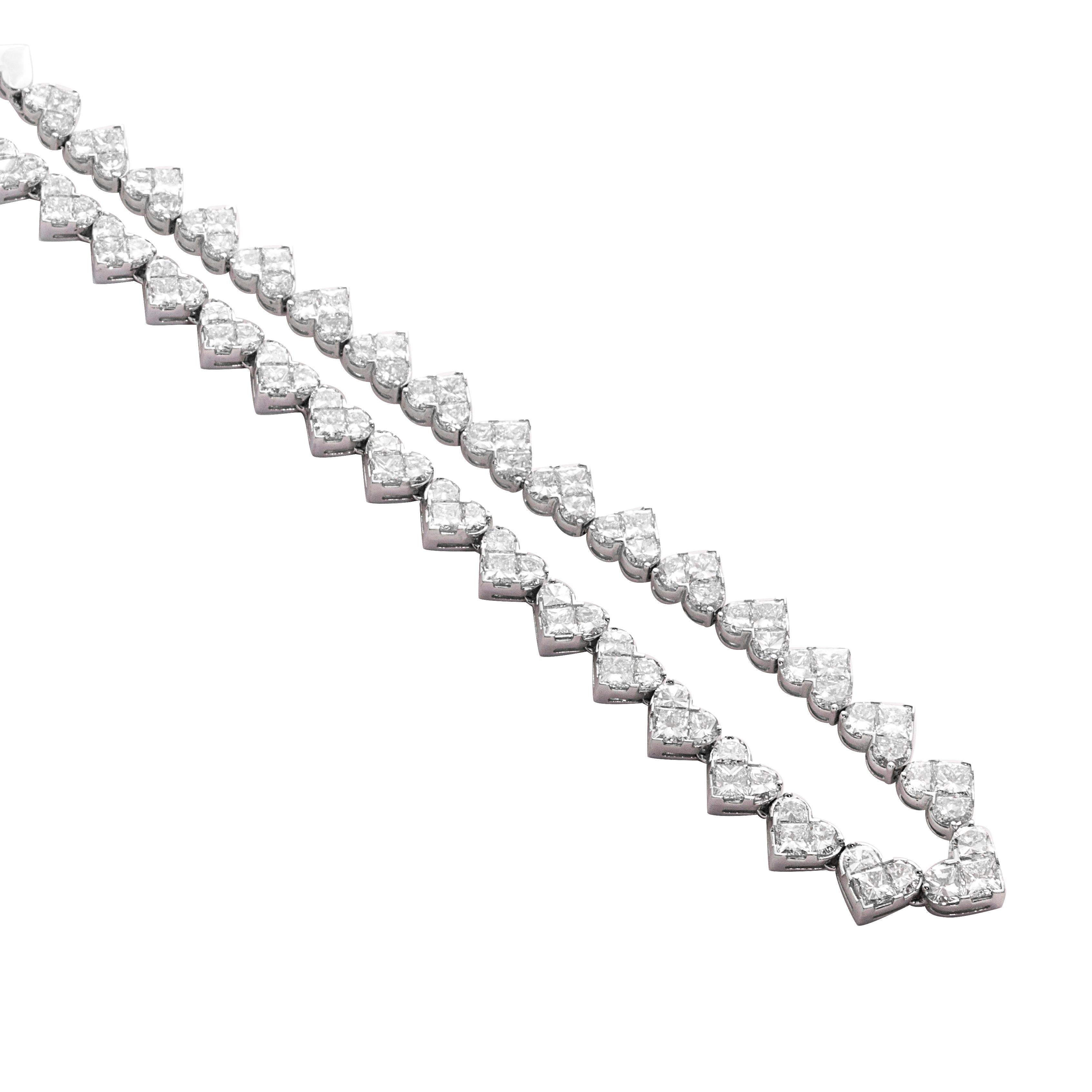 18 Karat White Gold Illusion Setting Diamond Necklace Set

This beautifully crafted diamond necklace set, effortlessly fuses together half moon cut and princess cut diamonds to create an illusion of heart shape solitaires. Diamonds are certified FG