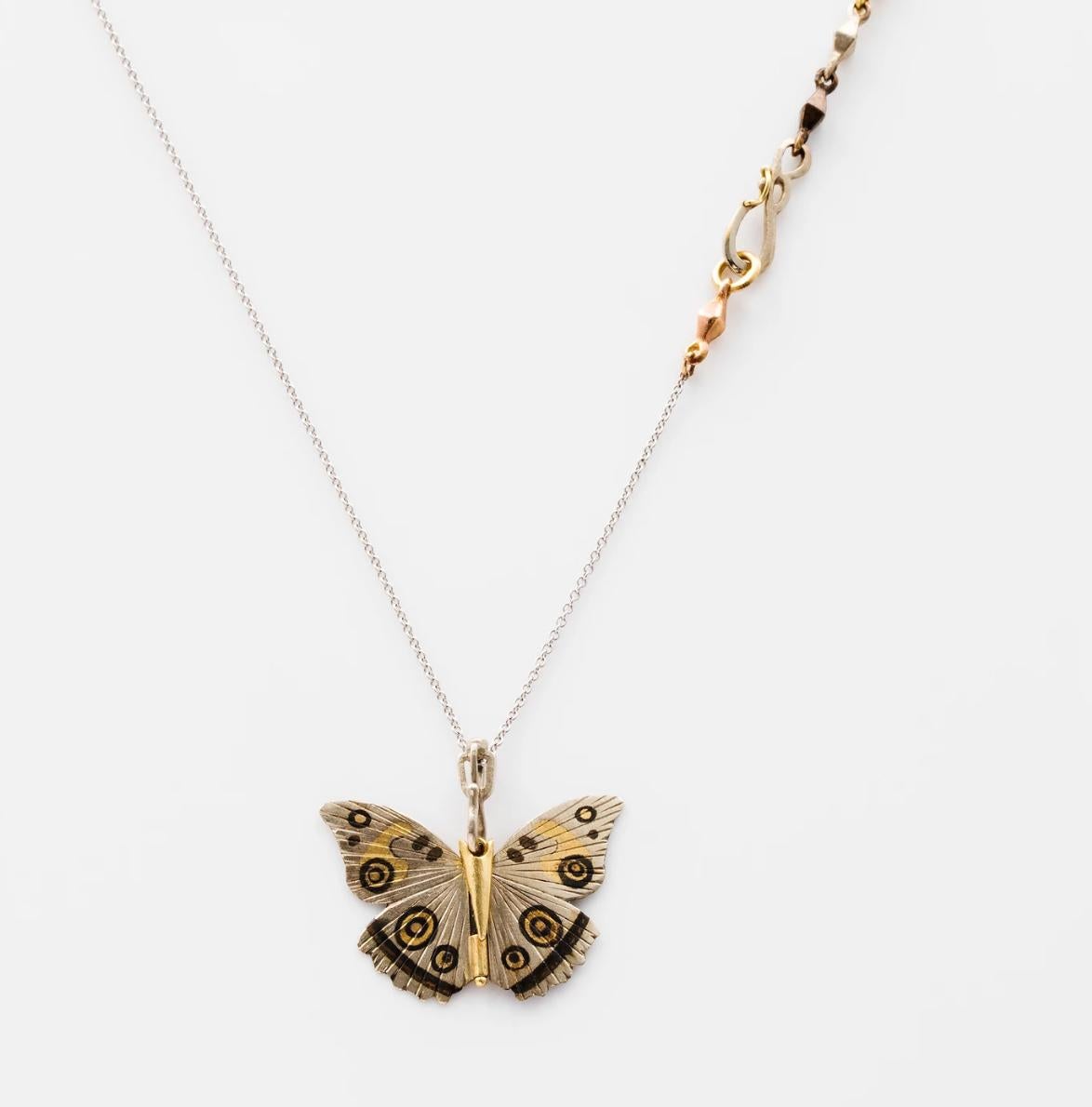 James Banks's signature butterfly necklace features a White Buckeye butterfly with a hinge at the center to allow movement of the wings, set in 18k White Gold with 18k Yellow Gold and Rose Bronze inlay hung on an 18k White Gold Chain and a single