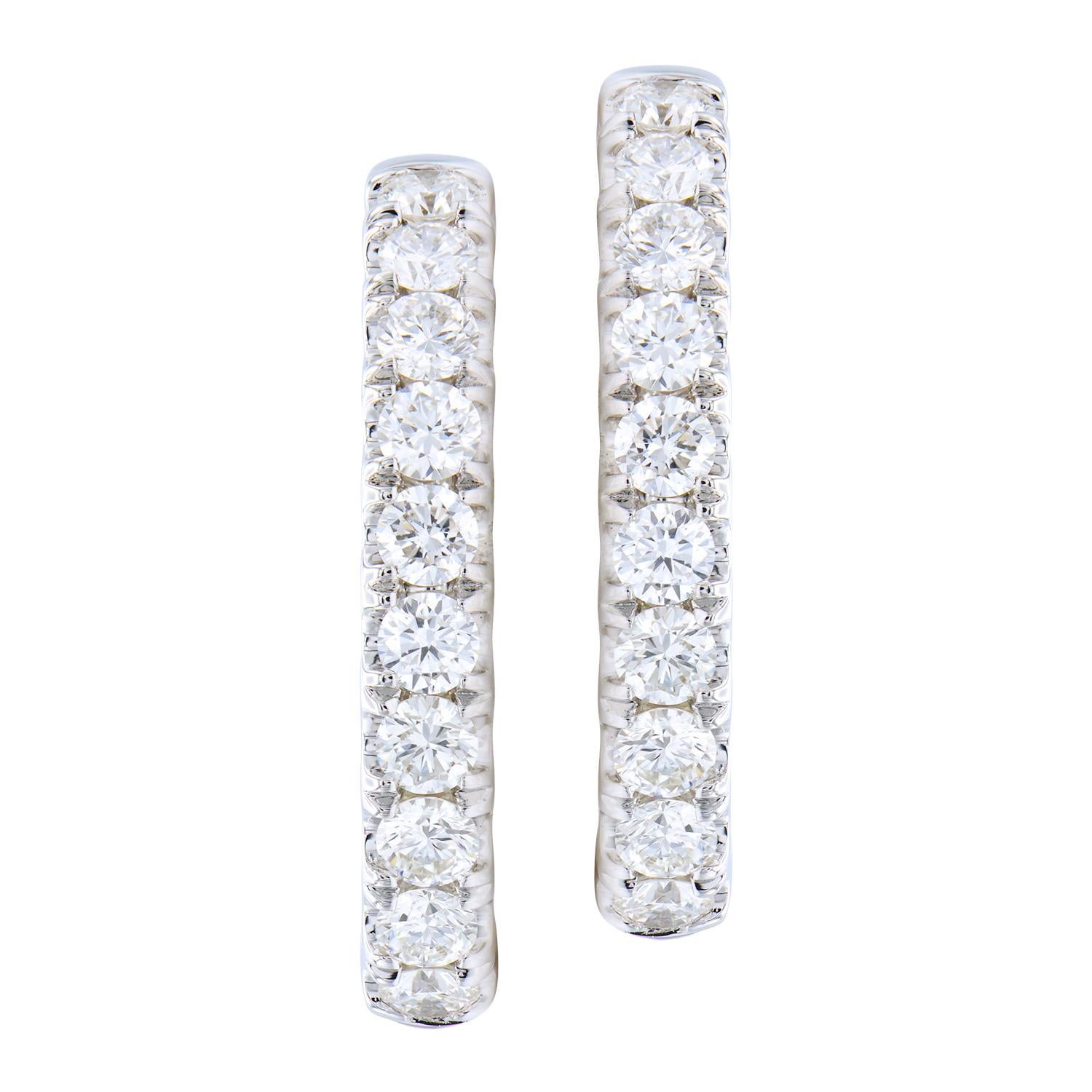 These stunning hoop earrings have diamonds on the inside and outside to give a beautiful sparkle from every angle. There are 32 round VS2, G color diamonds totaling 1.37 carats. 10 diamonds are on the front outside of the hoop and 6 on the inside of