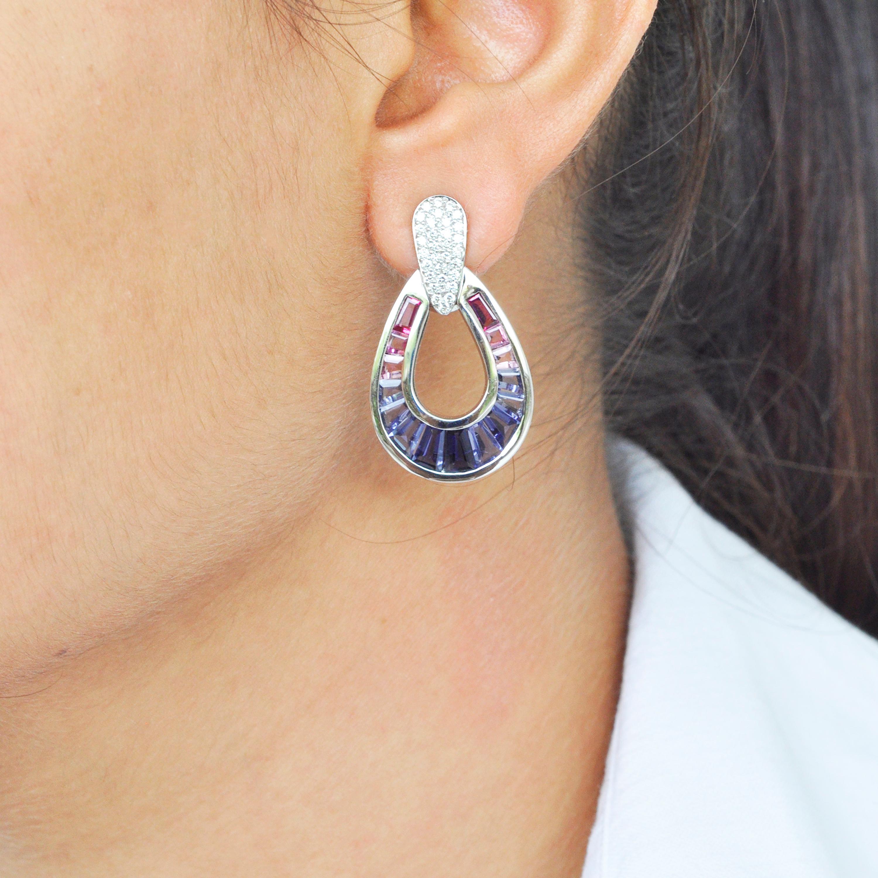 18 karat white gold natural iolite pink tourmaline taper baguette diamond dangle earrings.

Art, color and culture all come together to inspire this 18 karat white gold taper baguette iolite pink tourmaline diamond dangling teardrop earrings. The