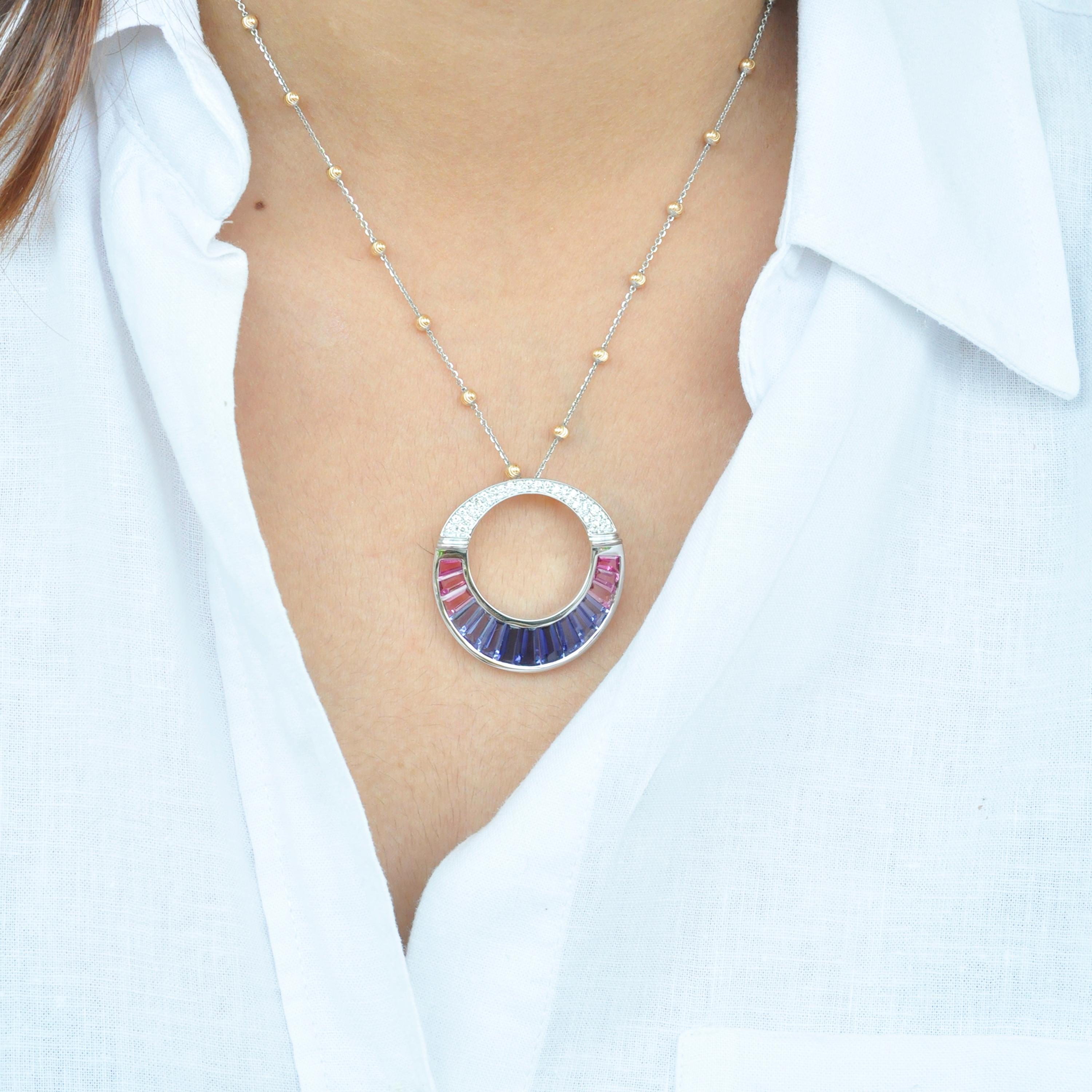 This 18 karat white gold iolite pink tourmaline baguette diamond circular pendant / brooch is inspired by the necklace worn by cleopatra in the egyptian era, giving it a contemporary make-over. The serene and pleasant shades of iolite and pink
