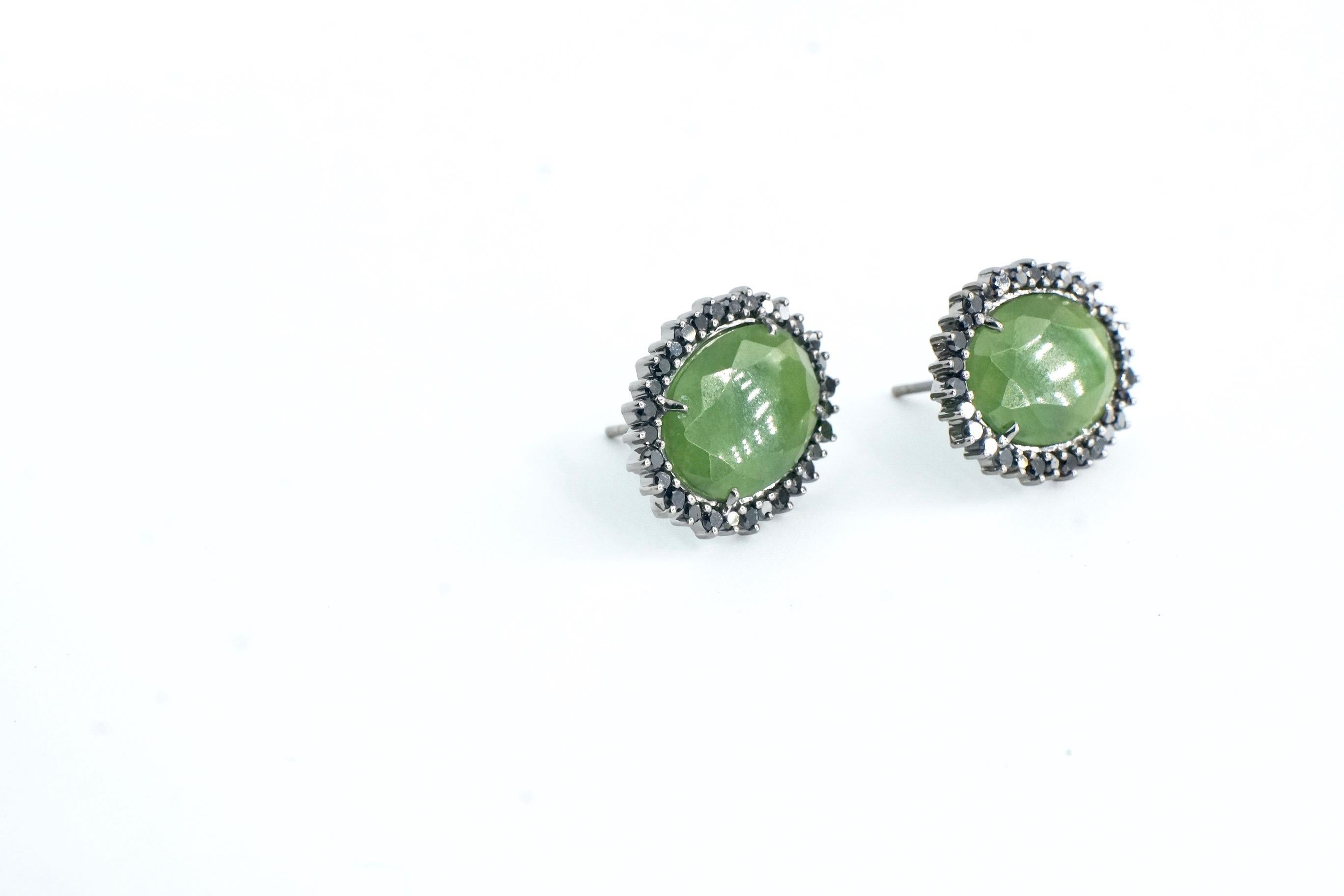Jade Martha Studs
A pair of eighteen-karat blackened white gold earrings consisting of an oval faceted green jade surrounded by black diamonds. 
Total Black Diamond Weight – 0.97 ct.
Total Jade Weight – 7.31 cts.
This piece is one-of-a-kind and