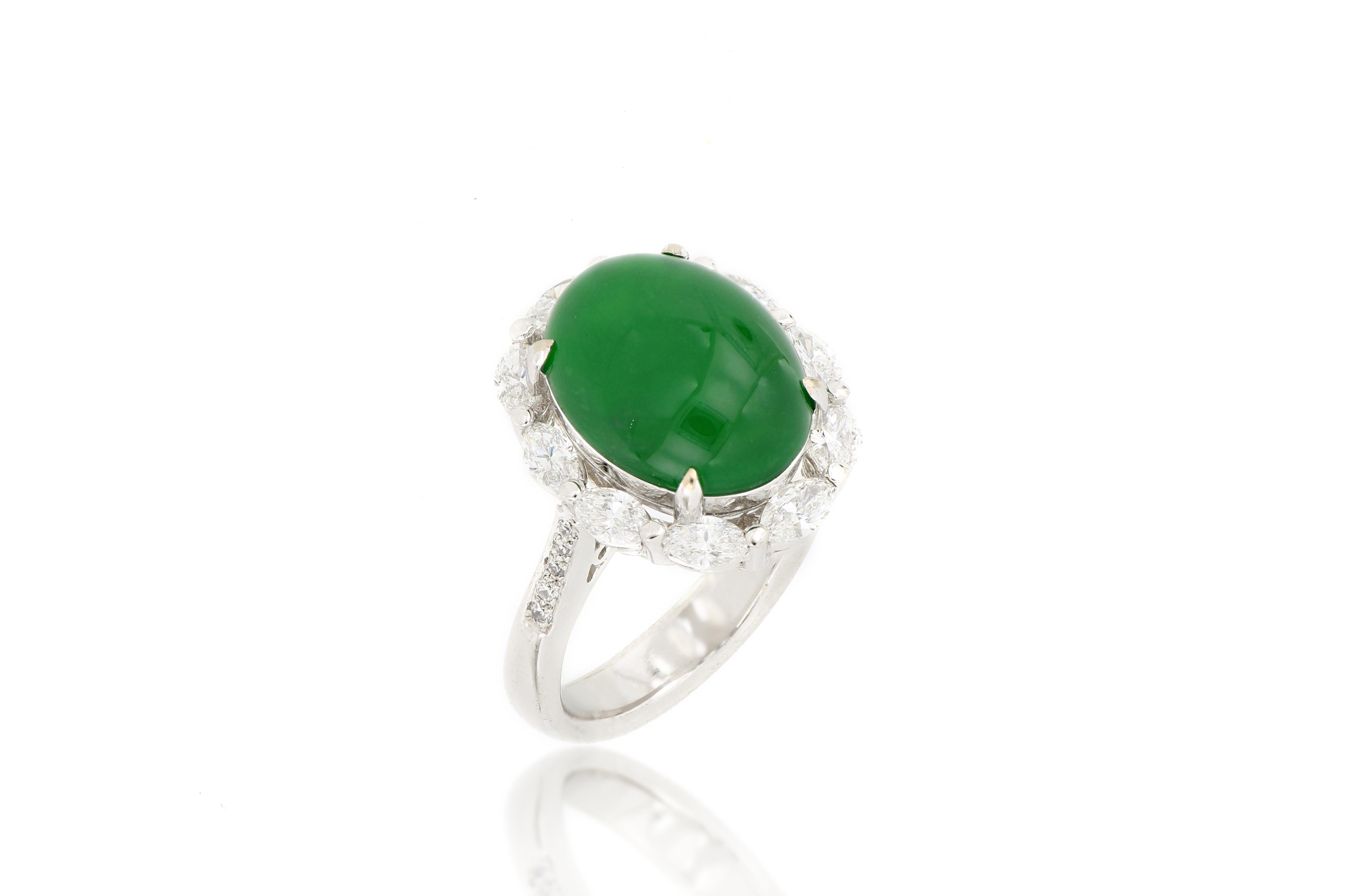 A magnificent piece of natural jadeite ring, centering a translucent oval jade cabochon of imperial bright green colour, is framed by  10 marquise-shaped diamonds and decorated by 10 round diamonds on the shank, with a total weight of 1.11