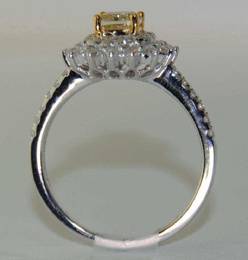 Cushion Center Fancy Diamond/Yellow Ladies Ring, surrounded by Brilliant Round White Diamonds total weight 1.24 Carats.  Made of 18 Karat White Gold, Size 6.5.   