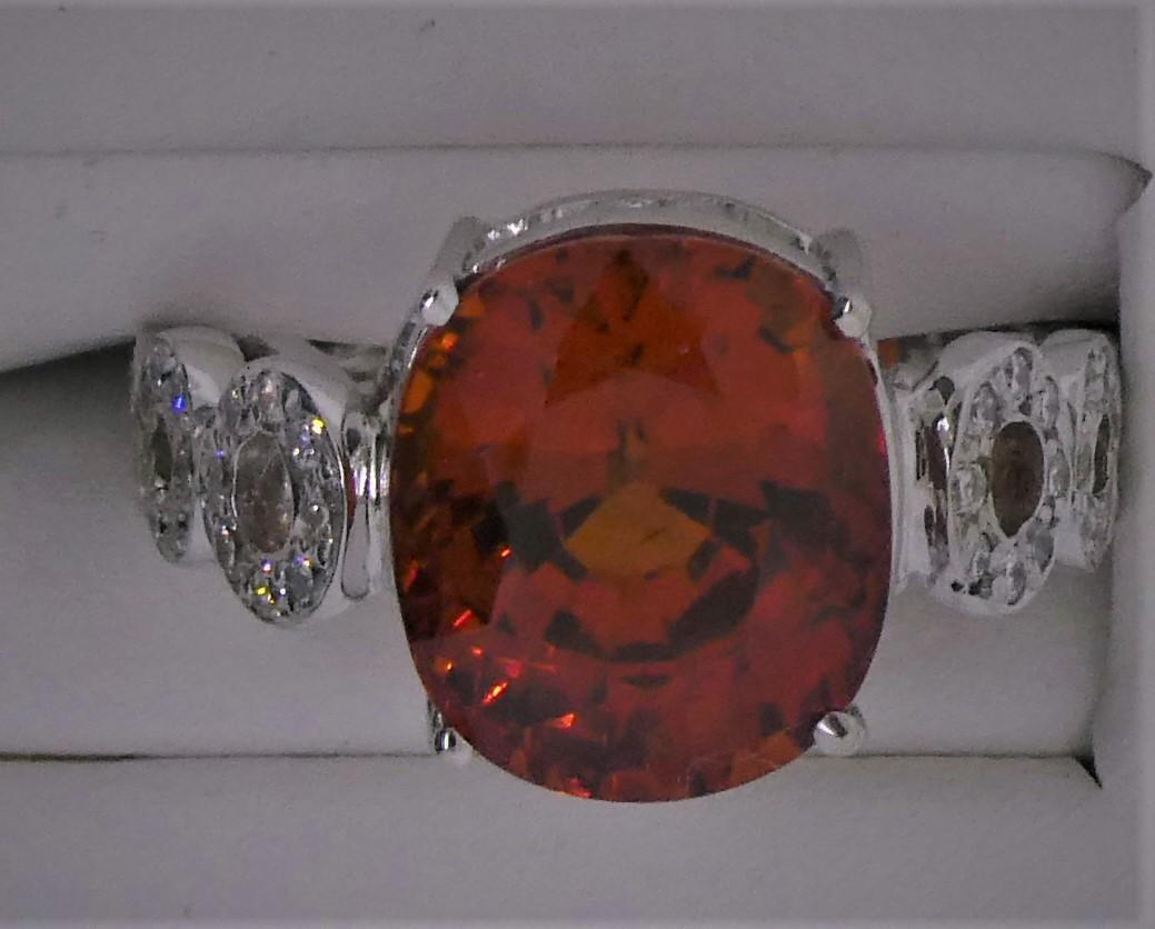 Designer and creator Michael Engelhardt brings you this beautiful and extremely rare Mandarin Garnet Ring.  Weighing 8.44 Carats, set in 18 Karat White Gold, and mounted with the aid of 46 diamonds 0.62 carats, this exceptionally clean Mandarin
