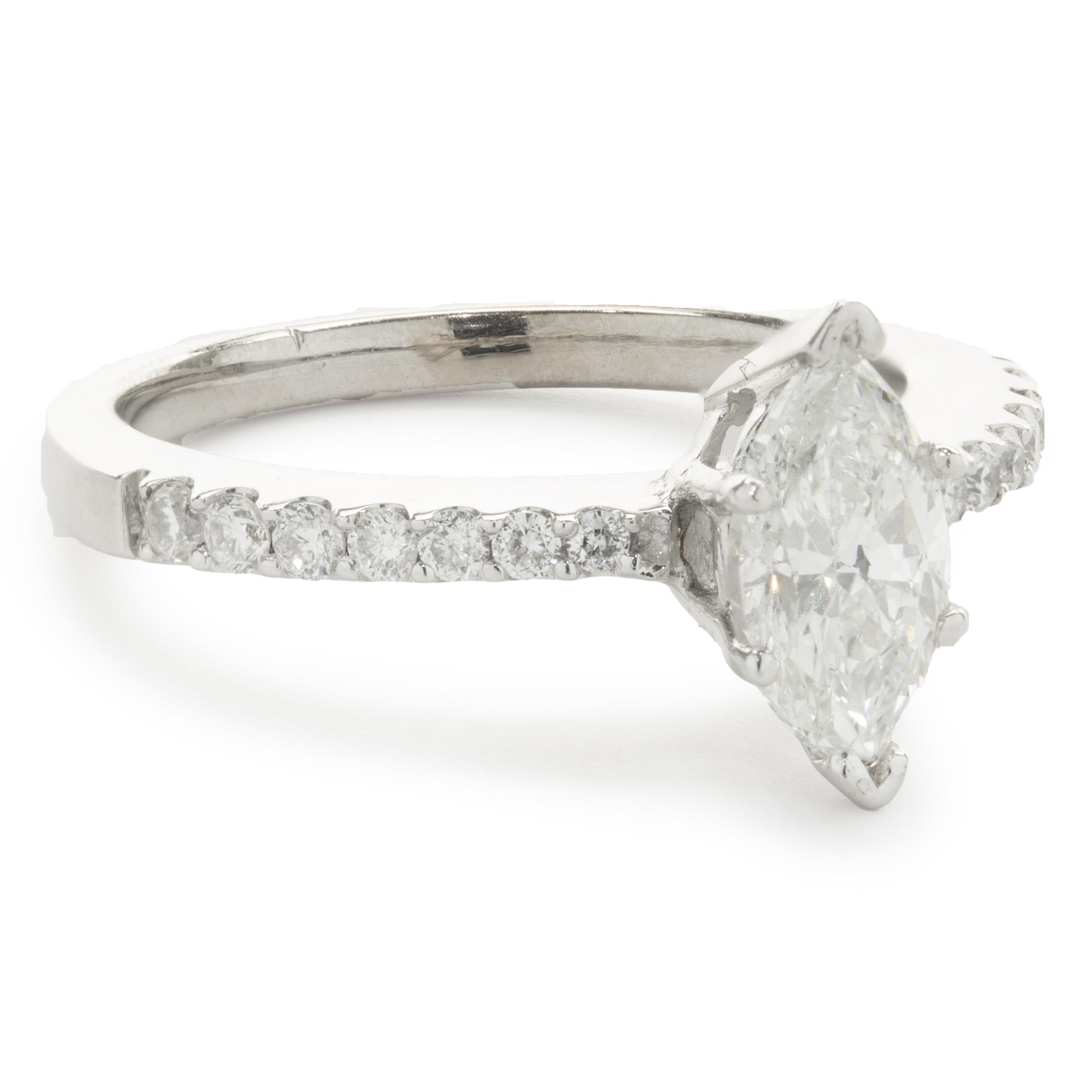 Designer: custom
Material: 18K white gold
Center Diamond: 1 marquise cut = 1.04ct
Color: I
Clarity: SI2
Diamond: 14 round brilliant cut = 0.25cttw
Color: G 
Clarity: SI1
Ring Size: 7.25 (please allow two additional shipping days for sizing