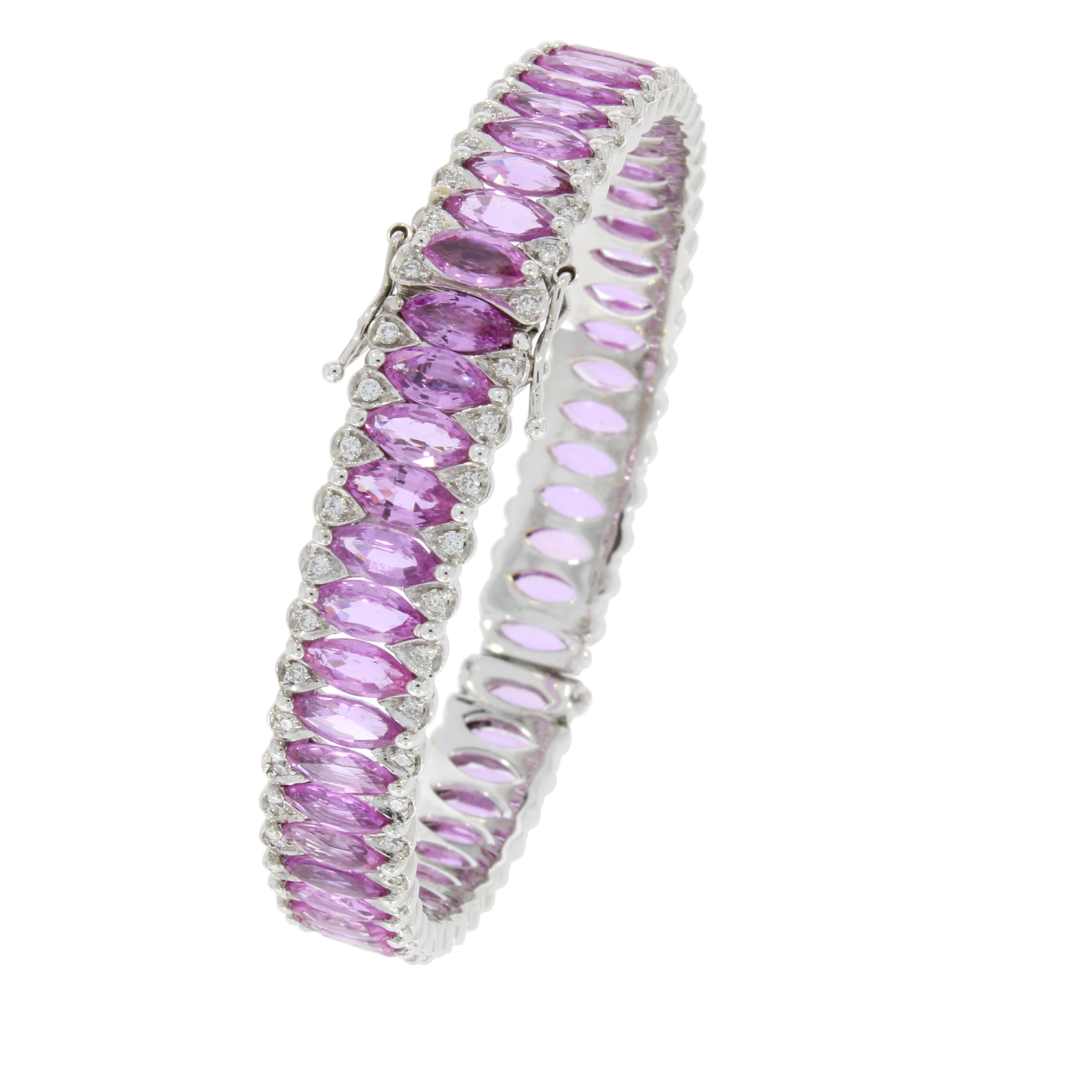 A perpetual circle of vibrant marquise cut pink sapphires poised between two delicate rows of brilliant cut diamonds fluidly wraps around the wrist.

- 18 karat White Gold
- 22.26 Carat Marquise cut Pink Sapphire
- 1.06 Carat Diamond

 5.85 cm