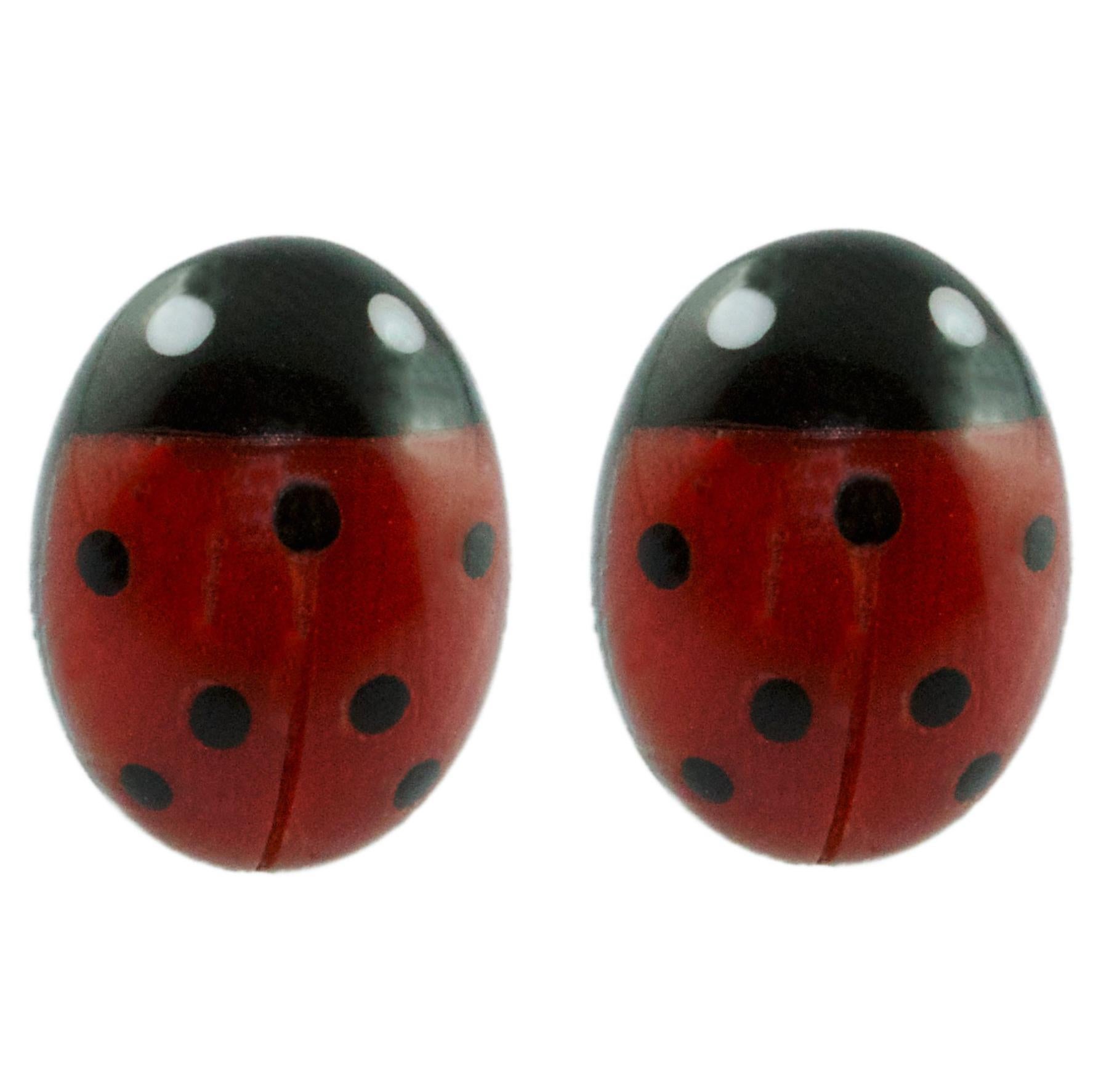 These stunning stud earrings are made with amazing coral sourced in the Mediterranean and Onyx, each face have been hand-carved shaped like a ladybug with a smooth, bulging surface. 
The black dot have been hand carved in onyx and mounted in the