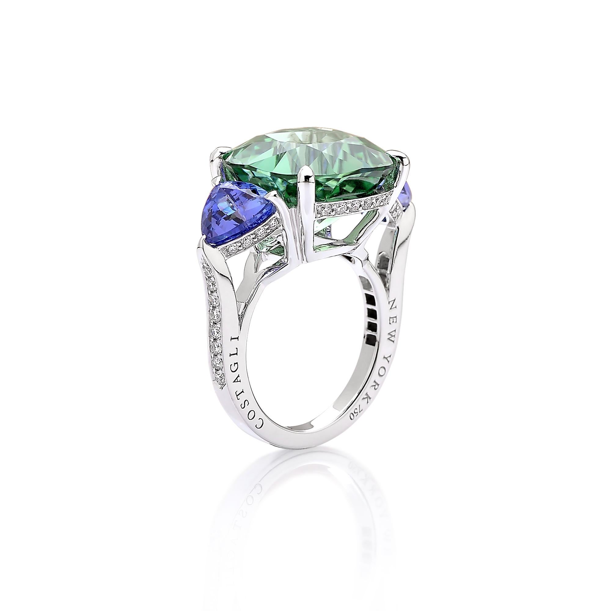 One of a kind cushion shape mint tourmaline ring flanked by trillion shape tanzanites set in 18kt white gold with pave-set round, brilliant diamond detailing. 

This ring features a classic silhouette that compliments the ideal cutting of the mint