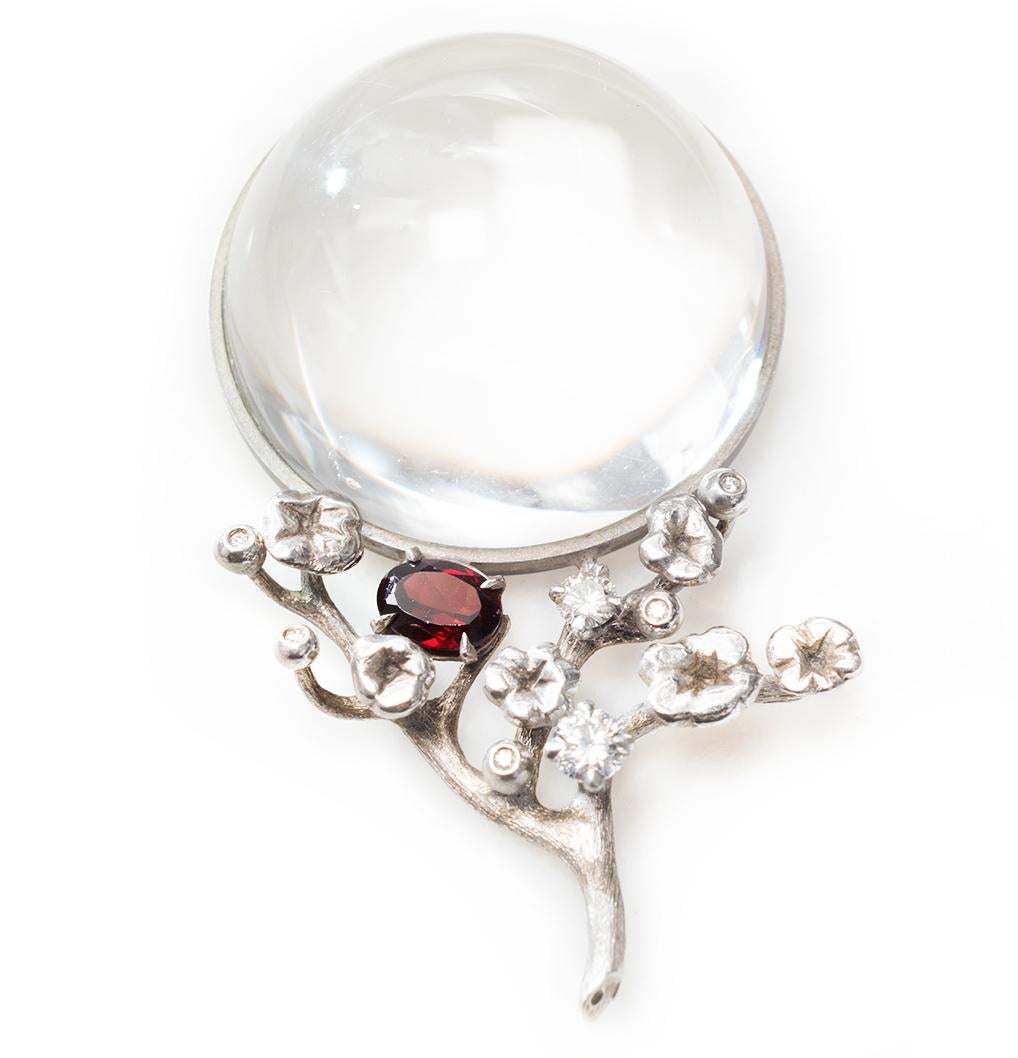 The Moon pendant is a necklace designed by an artist, made of 18 karat white gold with a half-sphere of rock crystal, diamonds (1.5 carats), and red rubellite.

This contemporary pendant was featured in the June issue of Vogue UA and was also