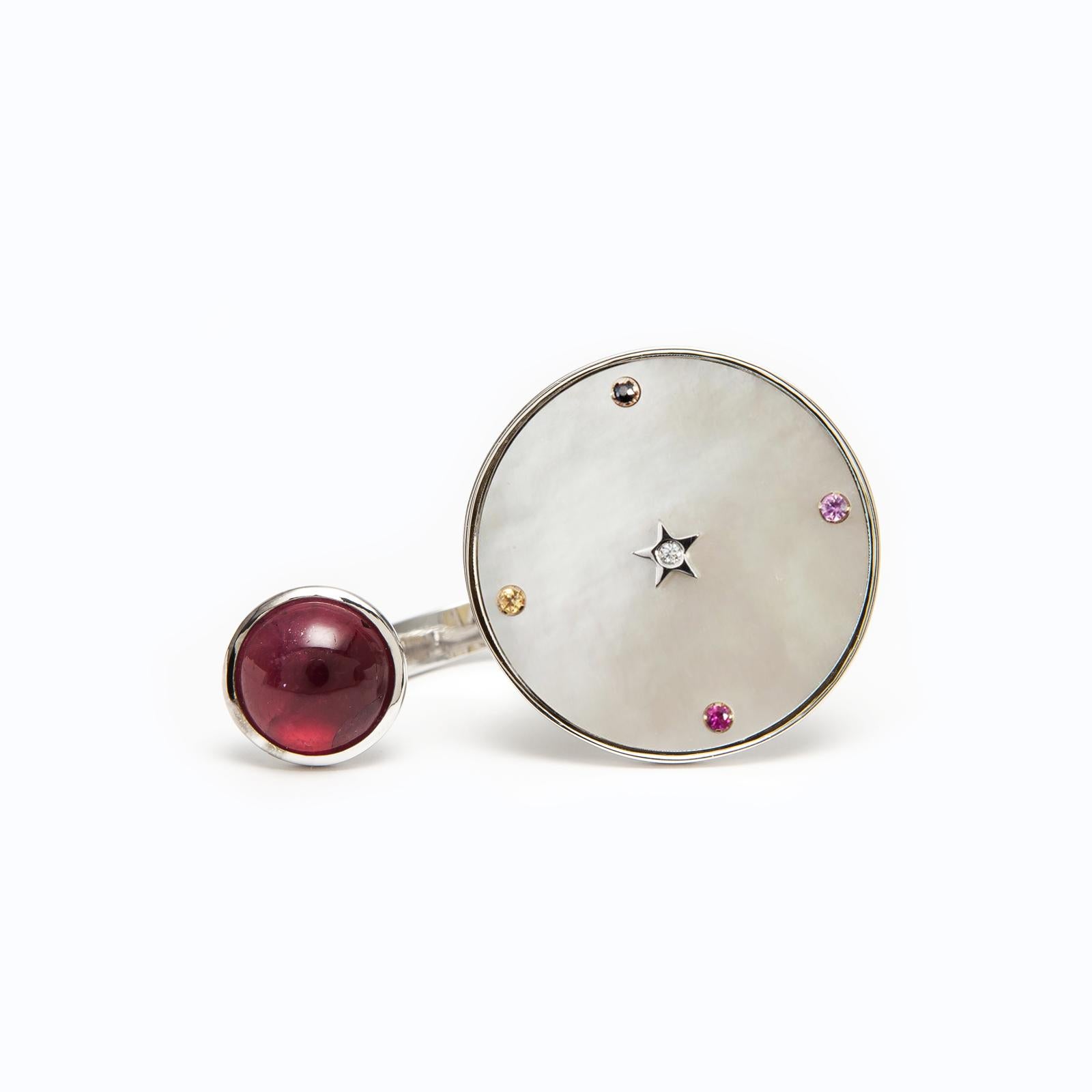 Inspired by the concept of time, Anna Maccieri Rossi's 'ORA Between Fingers Ring' features a pink tourmaline cabochon and a mother of pearl dial where the hours of the day are marked by multicolored sapphires with a diamond star at center.
PRODUCT