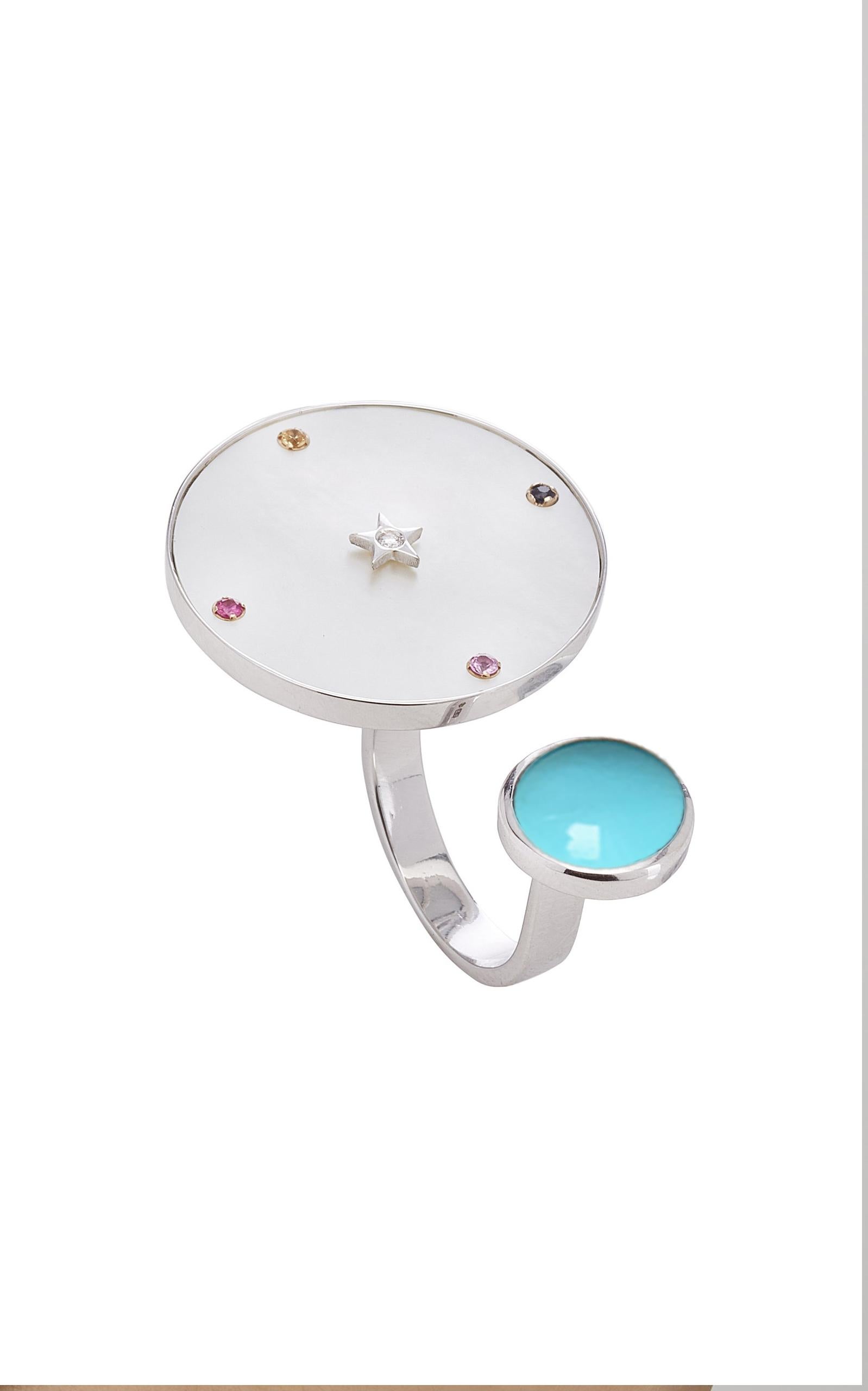 Ora Collection. Between Fingers Ring.
Inspired by the concept of time, Anna Maccieri Rossi's 'ORA Between Fingers Ring' features a natural turquoise cabochon and a mother of pearl dial where the hours of the day are marked by multicolored sapphires