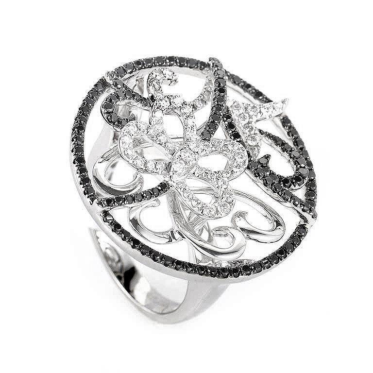 This ring is sweet and shines with diamonds. It is made of 18K white gold and boasts a butterfly accent set with ~1.17ct of black and white diamonds.
