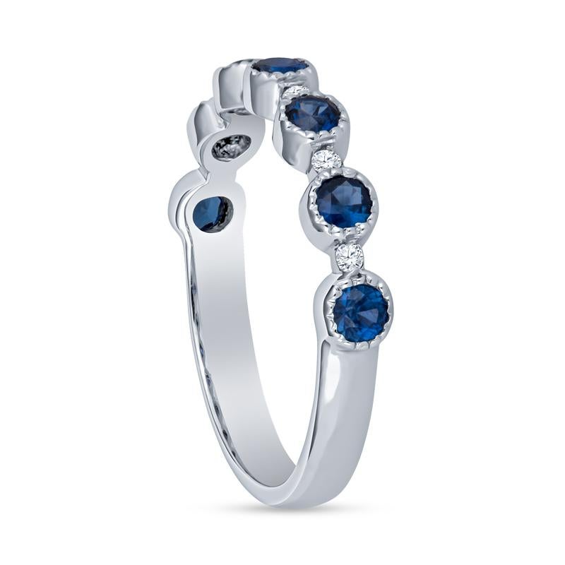 This 18 karat white gold stacking band features 0.60 carat total weight in round natural blue sapphires with milgrain detailing. They alternate with 0.15 carat total weight in round natural diamonds. Wear alone, stack with your engagement ring, or