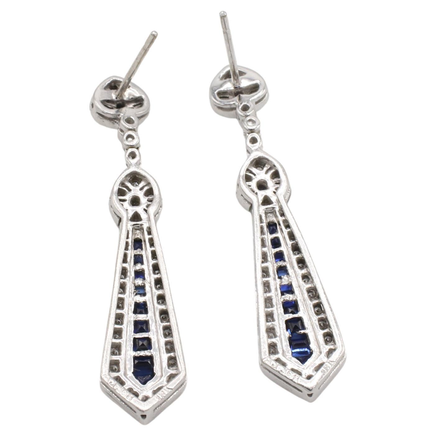 18 Karat White Gold Natural Diamond & Blue Sapphire Dangle Drop Earrings 
Metal: 18k white gold
Weight: 10.85 grams
Length: 1.75 inches
Diamonds: Approx. 0.75 CTW round natural G-H VS diamonds
