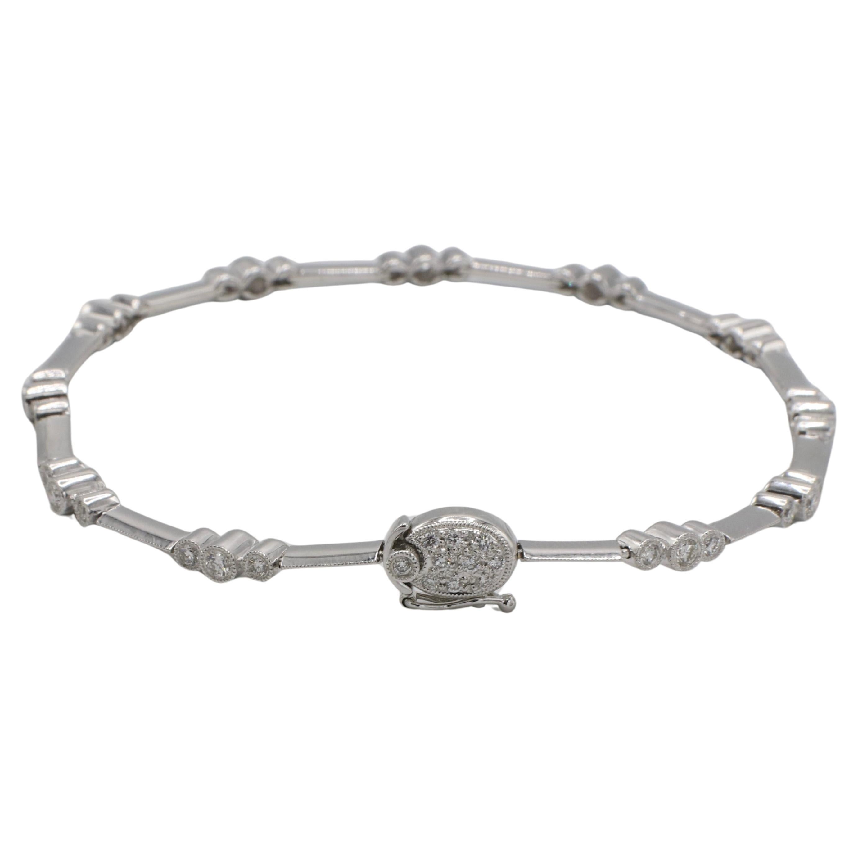 18 Karat White Gold Natural Diamond Station Knife-Edge Tennis Line Bracelet 
Metal: 18k white gold
Weight: 9.61 grams
Diamonds: Approx. 1.20 CTW F-G VS round natural diamonsd
Length: 7 inches
Width: 1-3mm
NTD 111183-7
