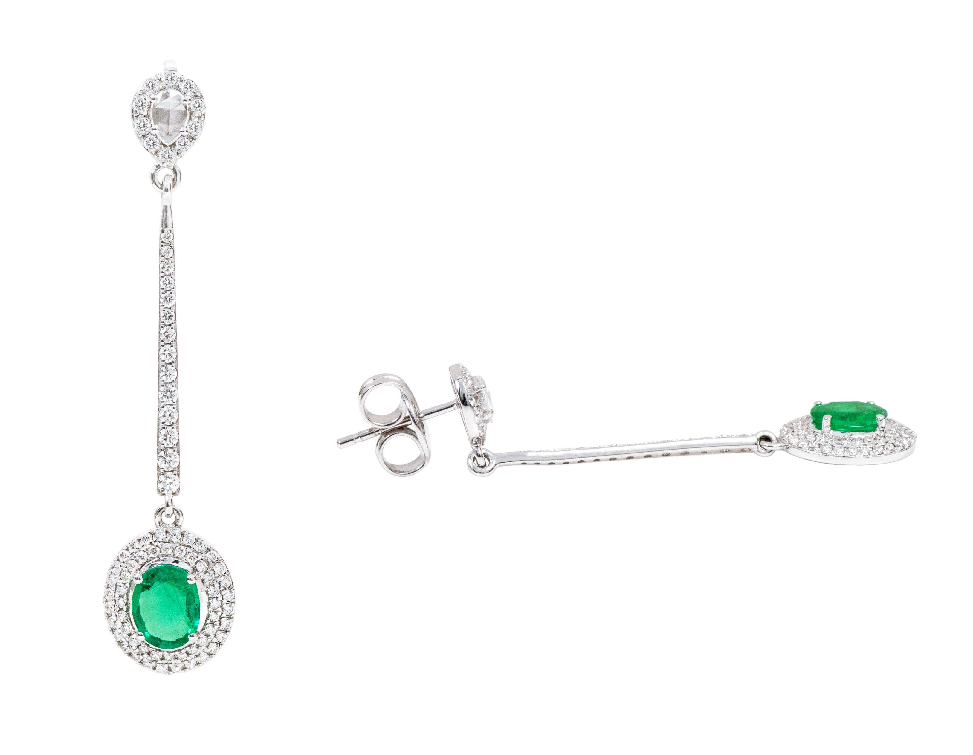 18 Karat White Gold Natural Emerald and Diamond Cluster Dangle Earrings

This sensational shamrock green emerald and diamond long earring is a beautifully crafted pair. The rose cut diamond pear solitaire stud surrounded with the classic micro-pave