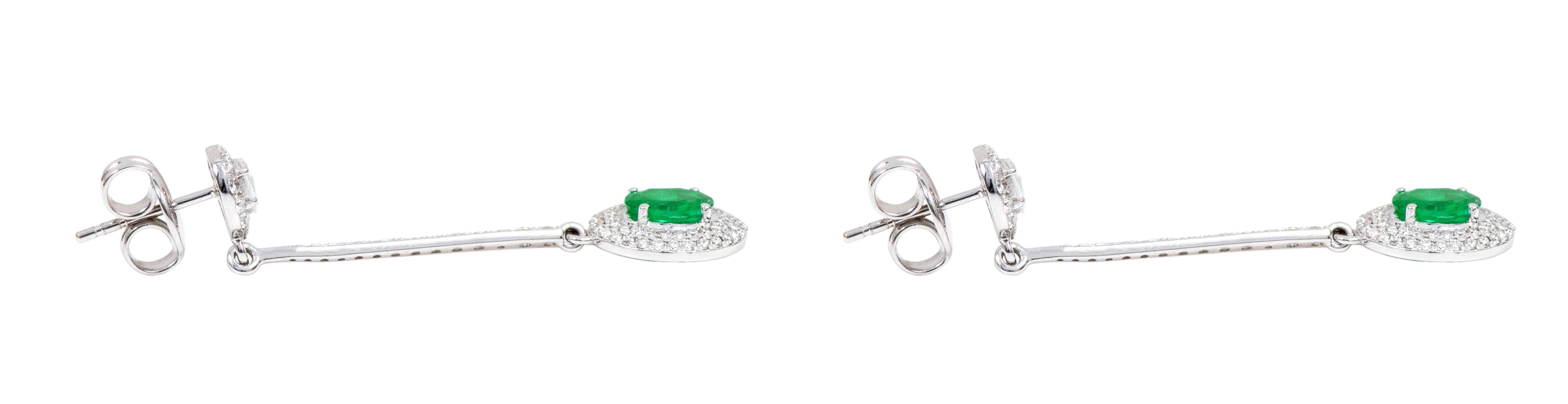 Oval Cut 18 Karat White Gold Natural Emerald and Diamond Cluster Dangle Earrings For Sale