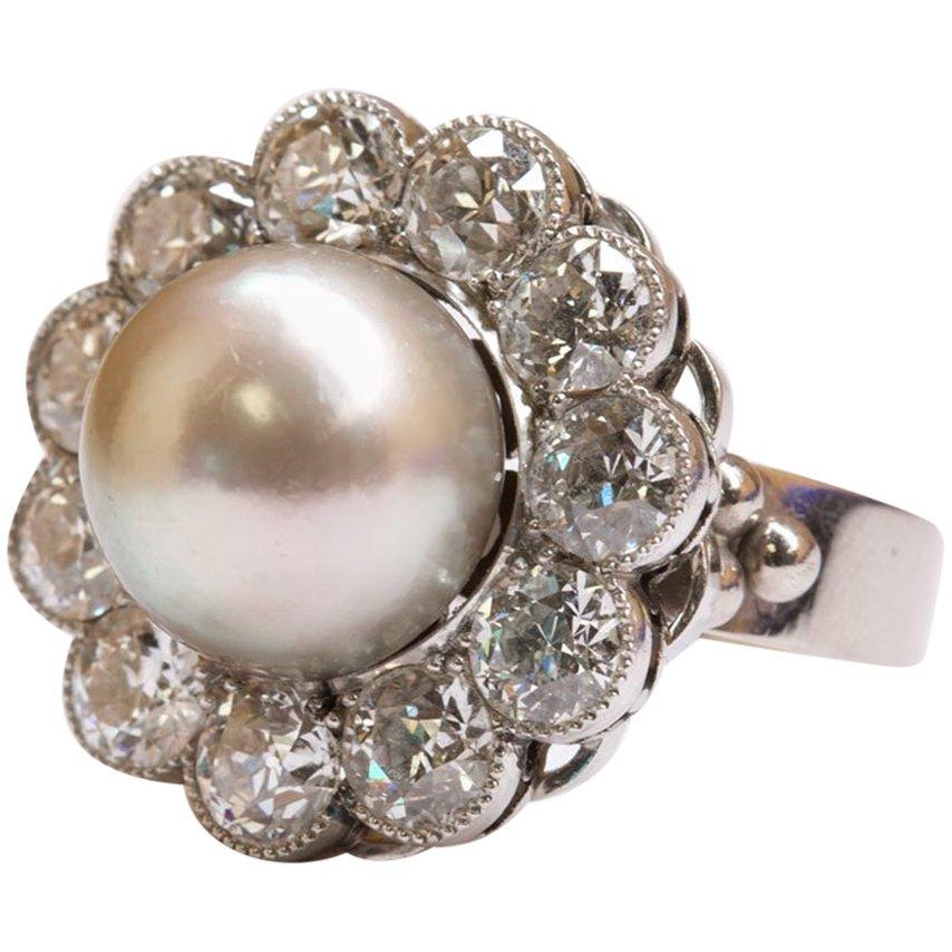 An absolutely show-stopping natural pearl and diamond ring 18K white gold ring. 

This spectacular natural pearl and diamond ring has such a charm to it. The alluring colour of the natural pearl against the diamonds makes both the pearl stand out,