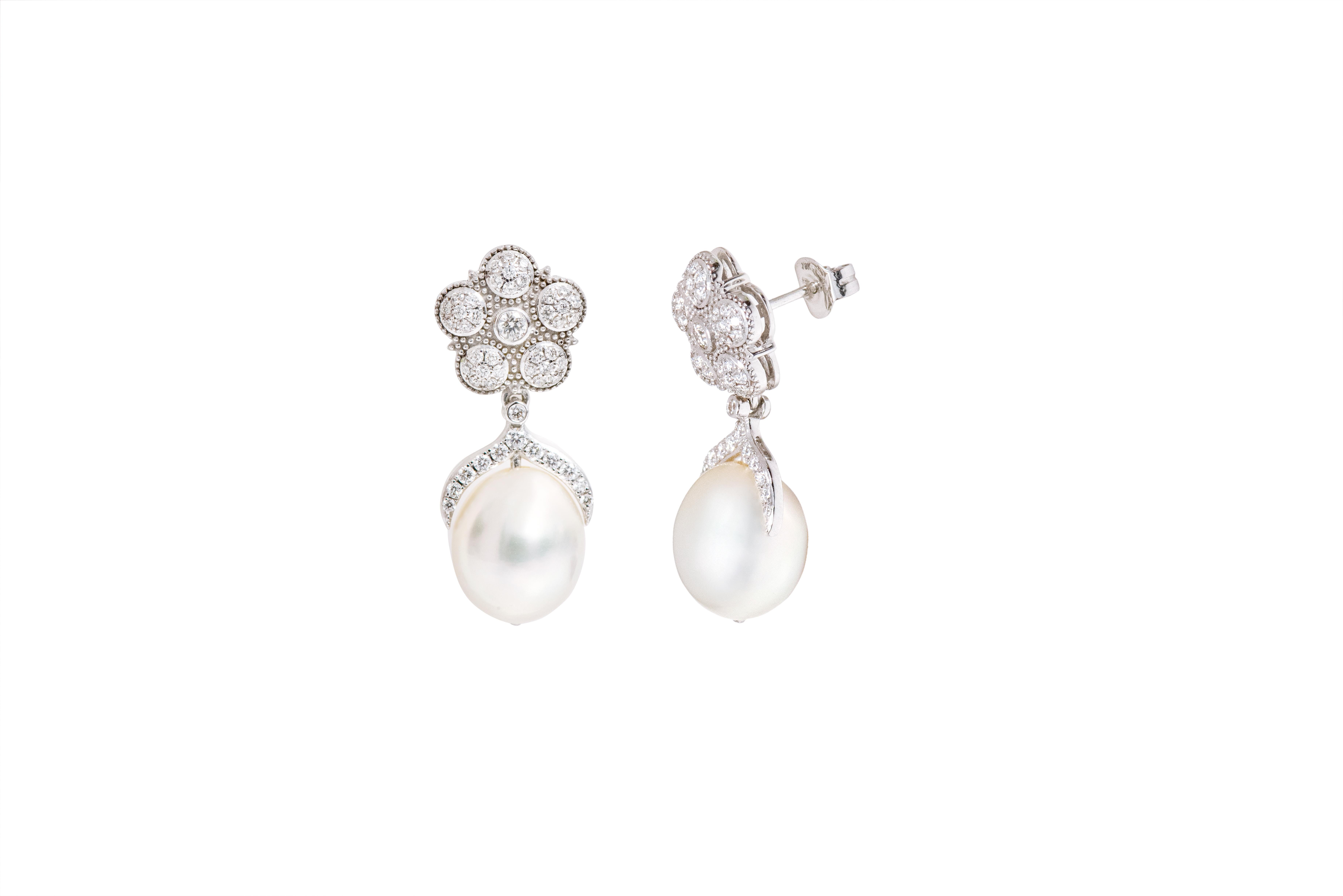 18 Karat White Gold Natural South Sea Pearl and Diamond Drop Earrings 

This immaculate uncanny ovalish-round pearl drop with the elegant pentagonal diamond stud top is a magnificent elevated design pair. The diamond stud with the solitaire round