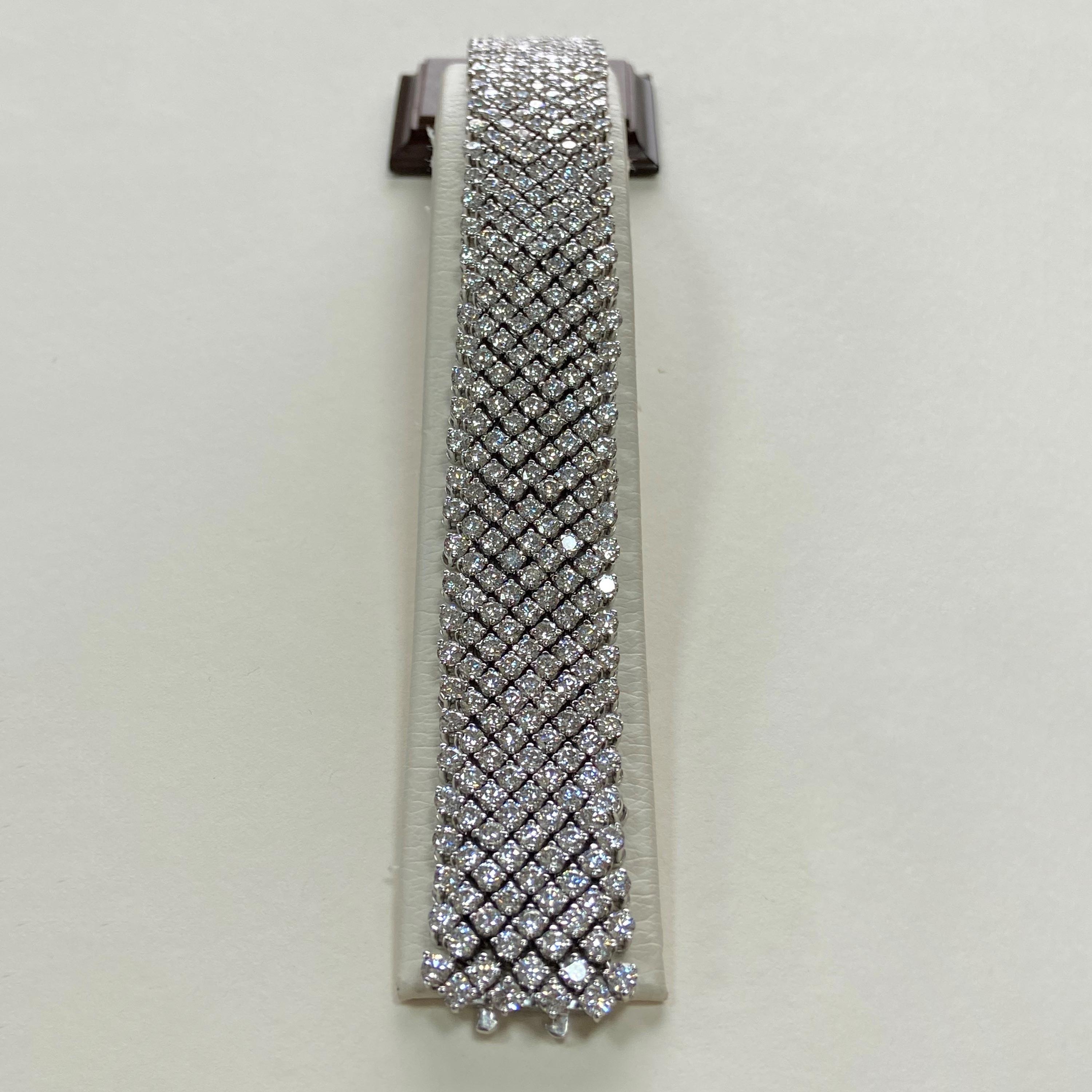 This 18 karat white gold flexible bracelet has nine rows totaling 360, I color, SI clarity diamonds with a total carat weight on 32.10.